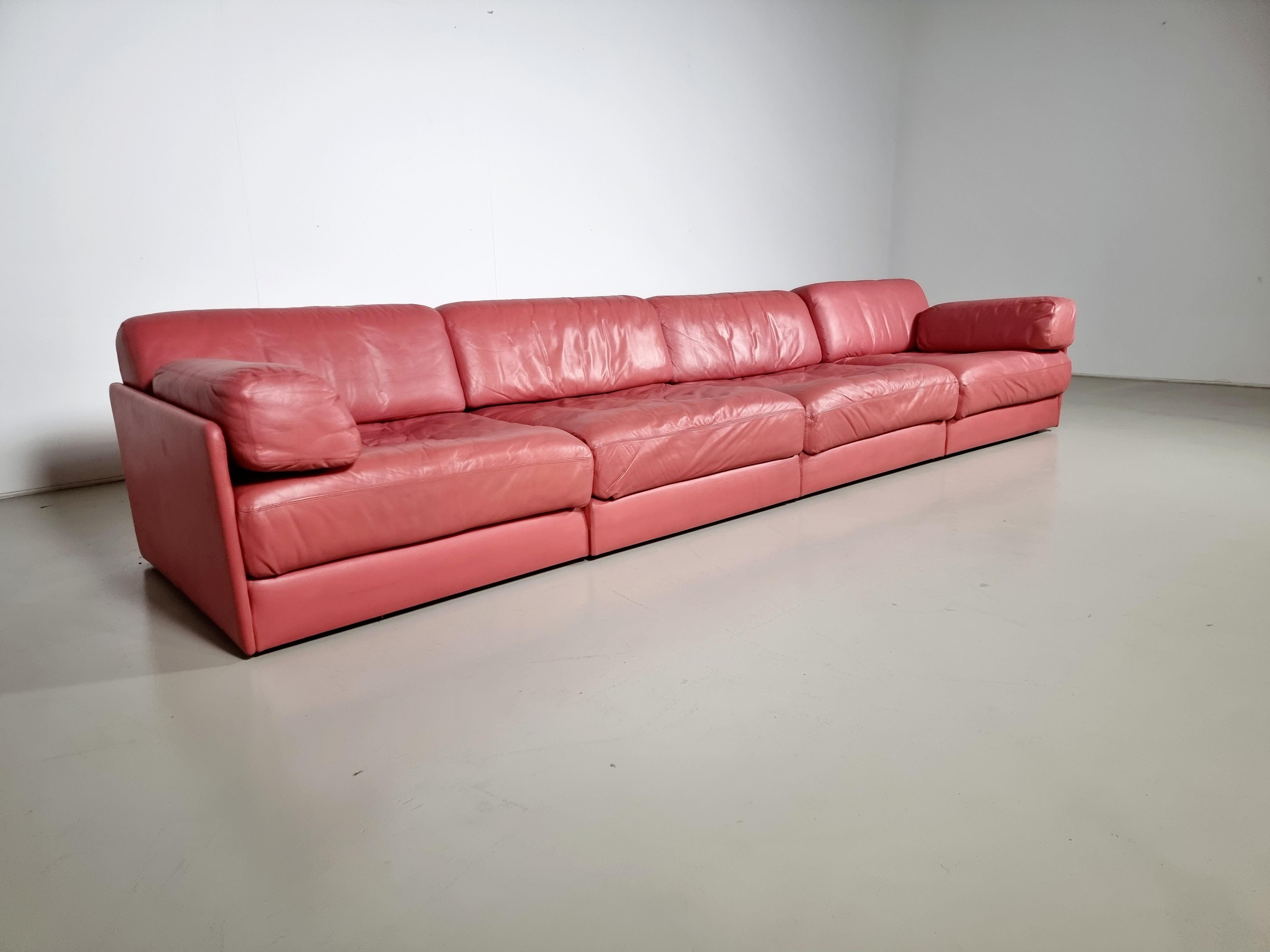 Beautiful 4-piece pink leather modular sofa by De Sede from the 1970s. The sofa can be converted into a guest bed in just a few simple steps. Extremely comfortable with a nice patina. Different settings are possible as shown in the pictures. The