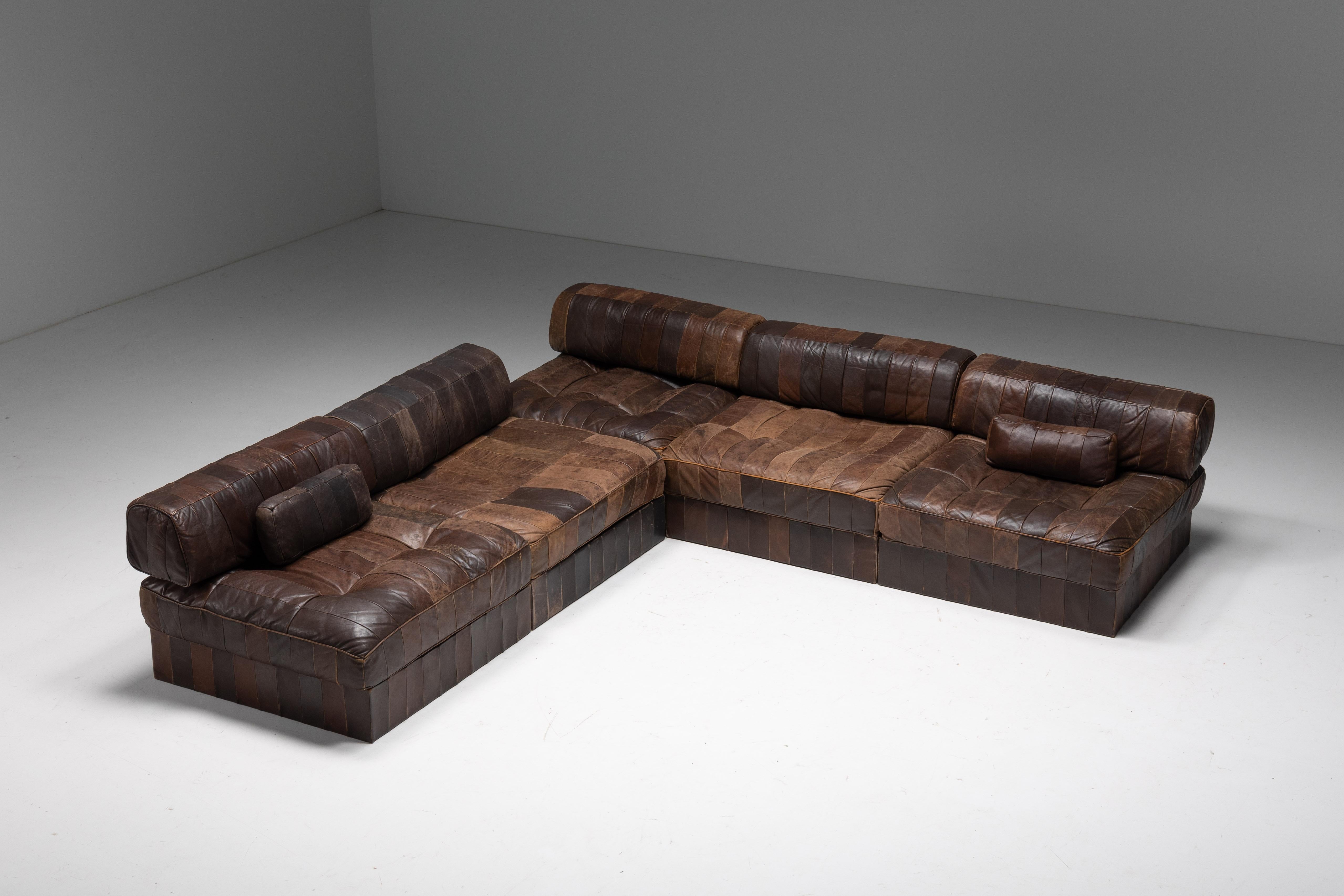DS 88 patchwork leather sofa, a timeless masterpiece designed and manufactured by De Sede, Switzerland 1970s. Crafted with precision and care, the sofa features rich brown patchwork leather with each element consisting of a soft base cushion and a