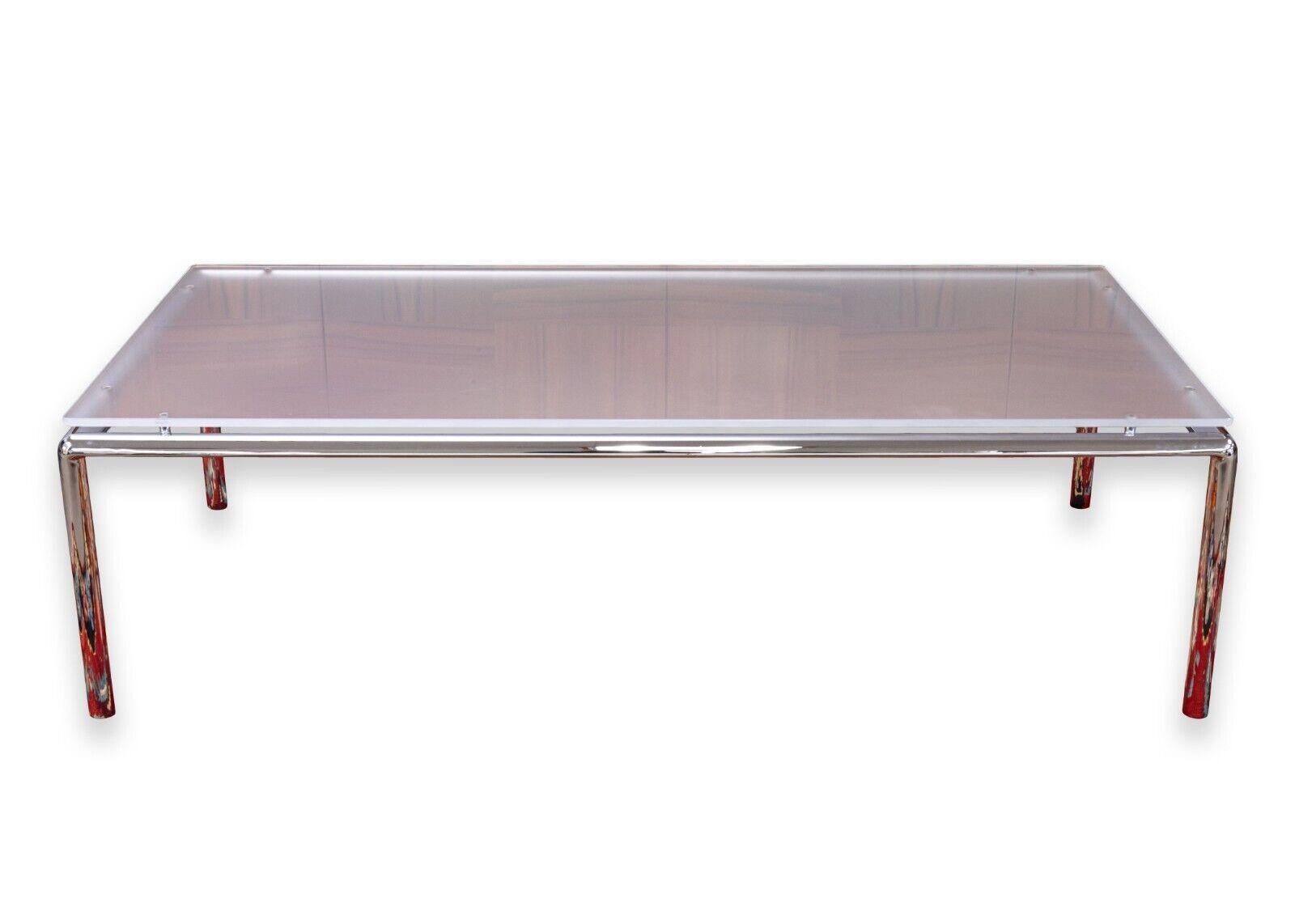 A de Sede DS-9075/62 Bauhaus coffee table. This is a wonderful contemporary modern coffee table. This table features a stainless steel base with a chrome finish, and a satin glass top with rounded corners. This is a beautiful table which gives off a