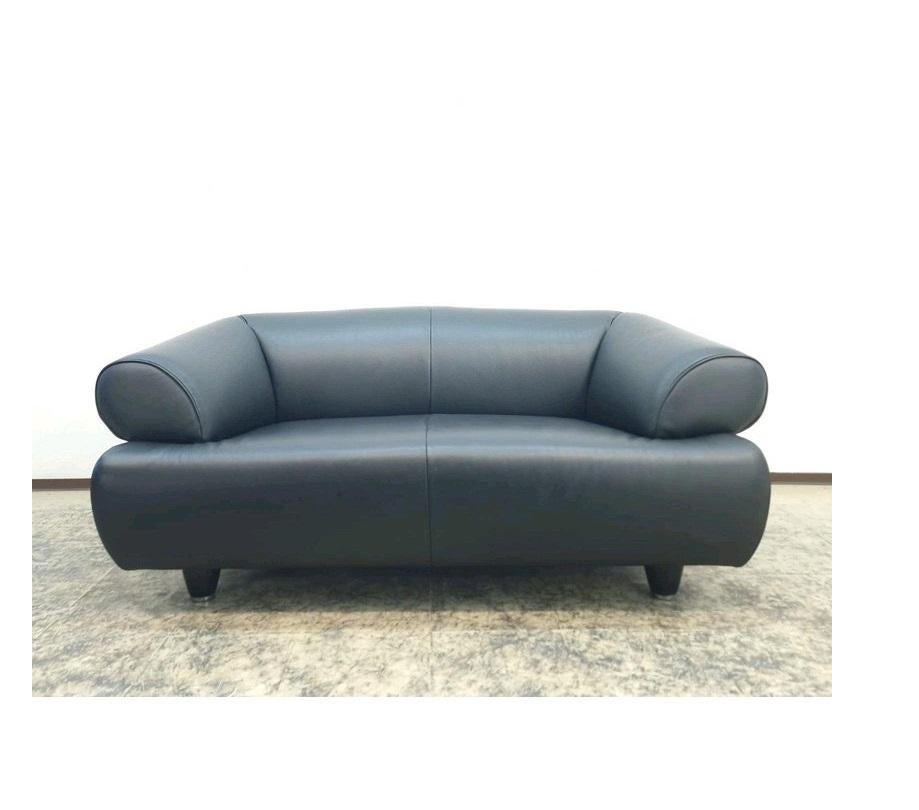 Ein herausragendes Beispiel zeitgenössischer Schweizer Möbelkunst: Der DS-91 Zweisitzer von De Sede, entworfen 1992 von Anita Schmidt. Die skulpturale Silhouette trifft auf kompromisslose Handwerksqualität - ein Statement für anspruchsvolles