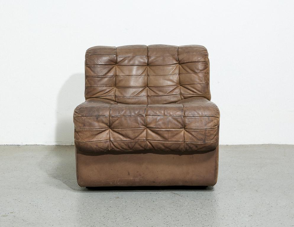 Vintage DS11 by De Sede, Switzerland. Patchwork leather upholstery featuring subtle tufting. Can be used as a lounge chair or part of a larger DS11 system. Measure: 15