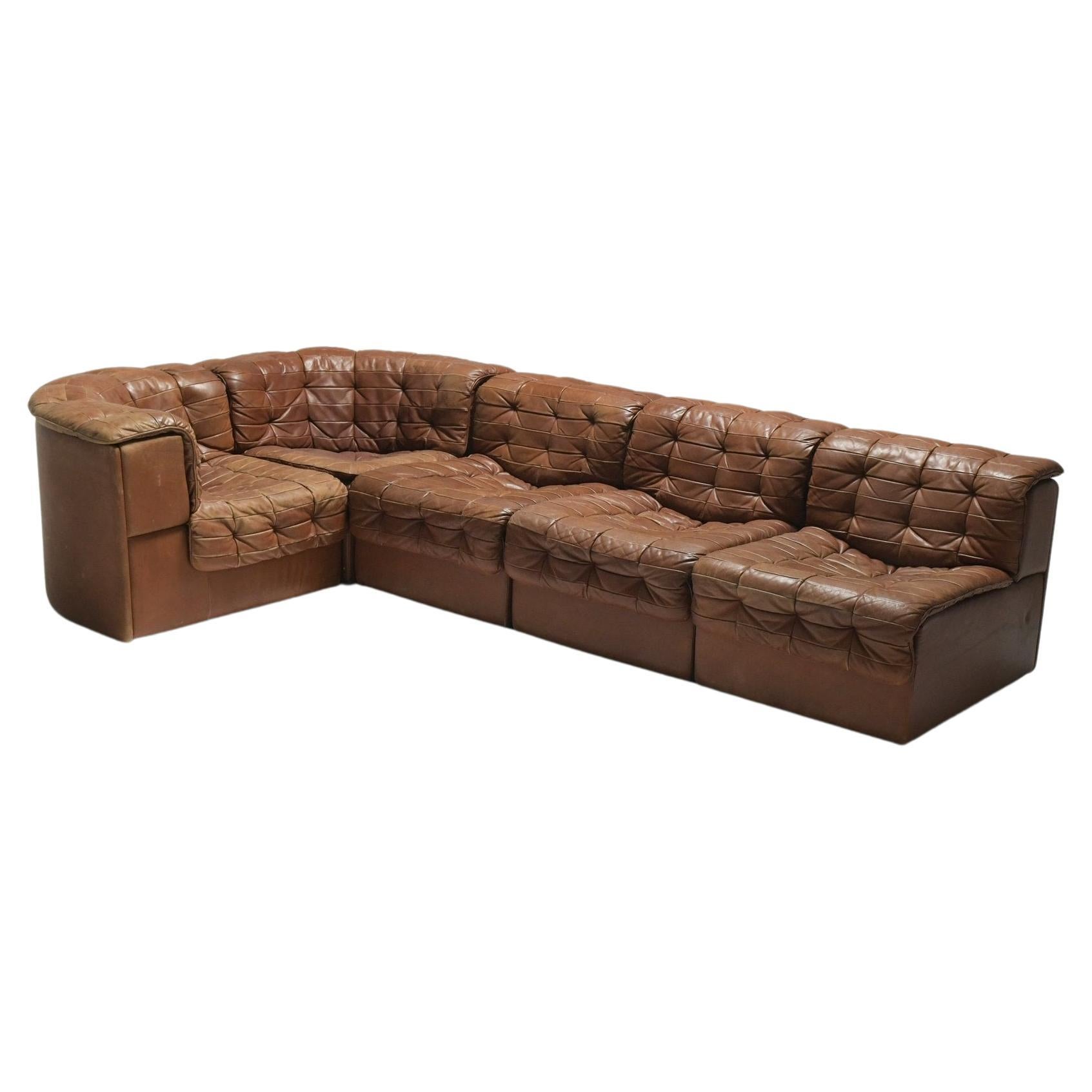 One of the most comfortable sofas ever made. This De Sede 'DS-11' sectional sofa features five pieces including two corner pieces. Switzerland, 1970s. 

It's beyond comfortable. The patinated patchwork leather is in a gorgeous caramel color.

Sold