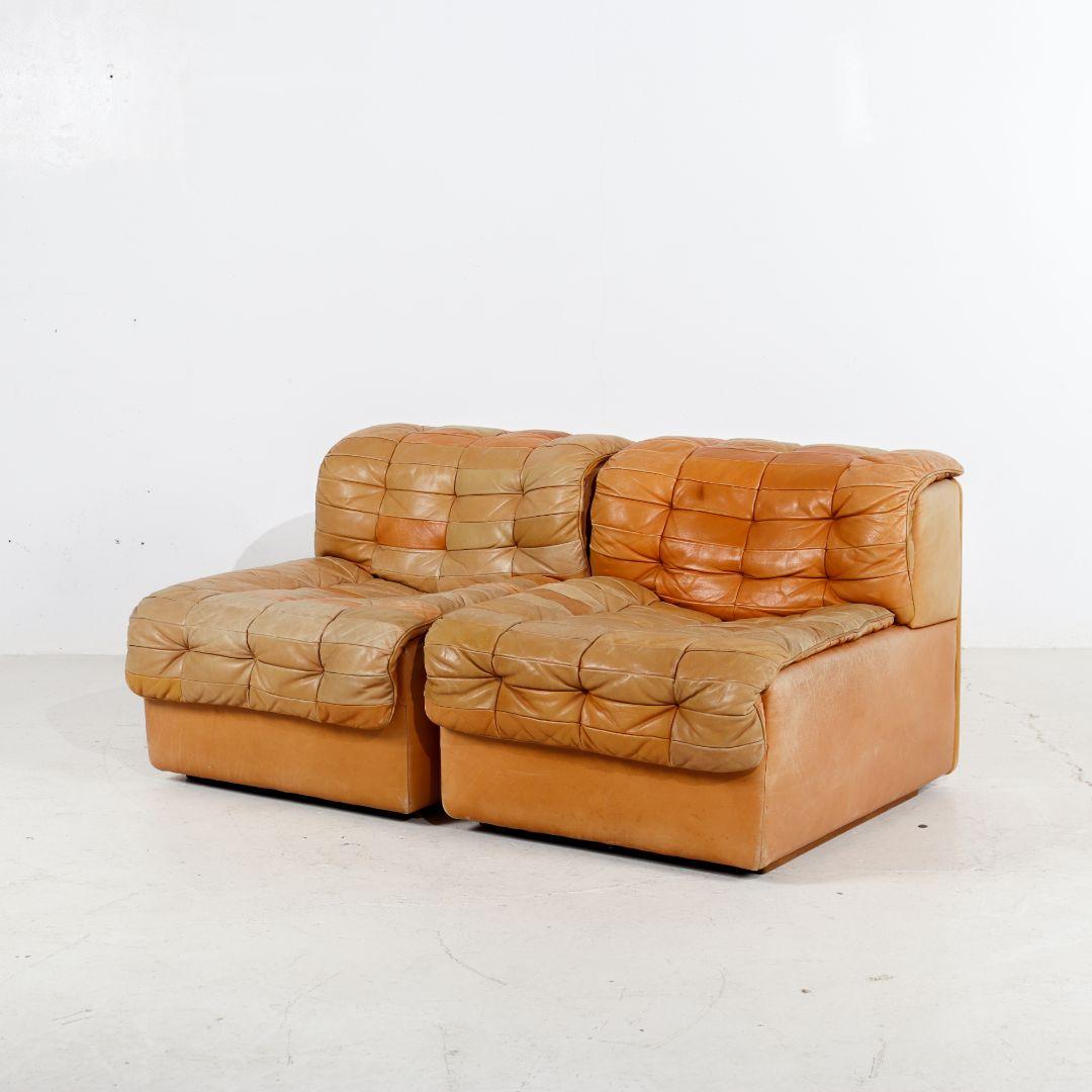 Mid-Century Modern De Sede DS11 'Patchwork' sectional sofa made of high-quality leather. De Sede is known for using only the very best types of leather. You can see this in the beautiful patina on these 70s elements. The mottled-cognac leather