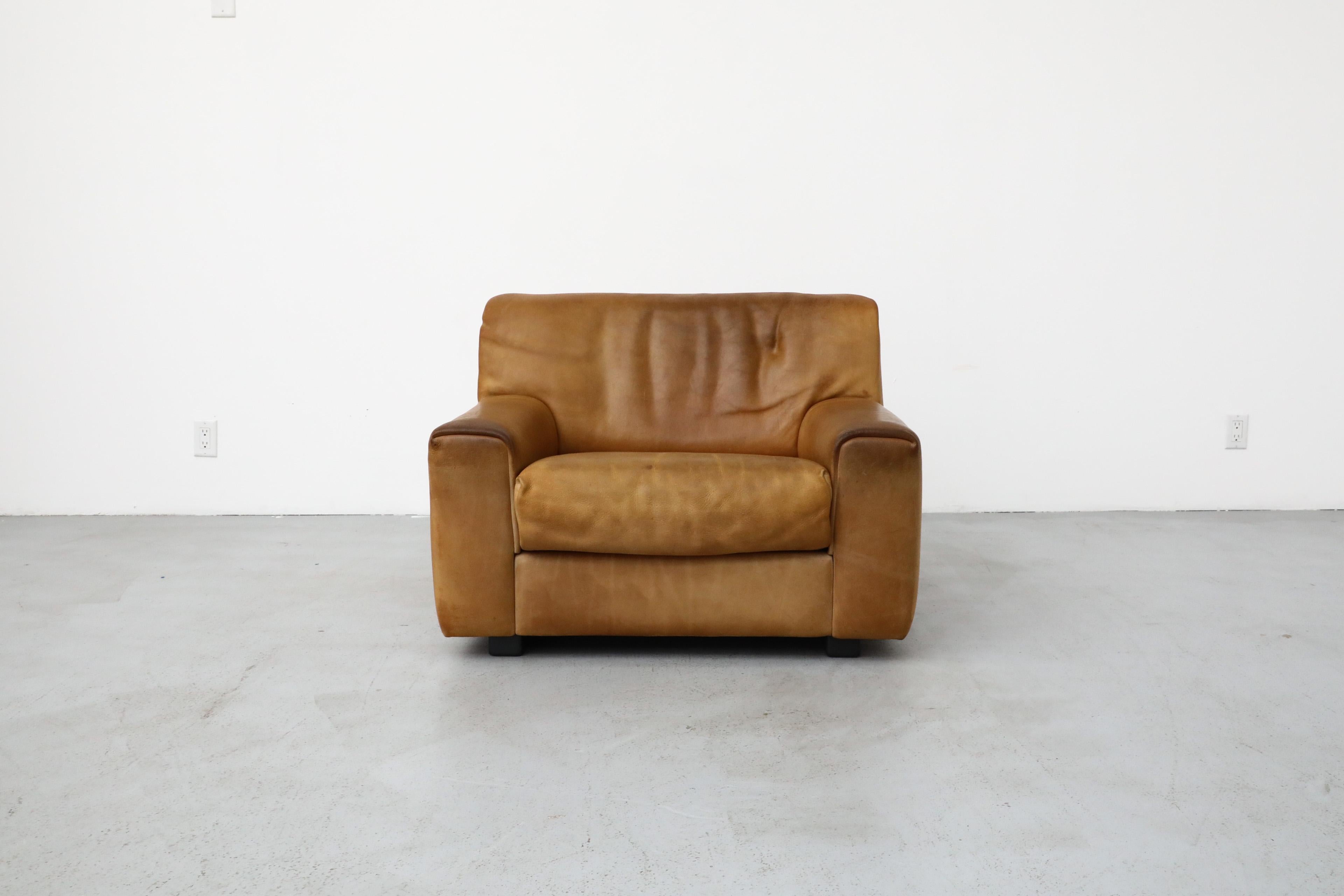 1980's, Swiss, De Sede DS42 leather lounge chair in original, warm brown leather with wonderful patina. De Sede, which began as a saddle atelier, began making handmade, premium leather-clad chairs, lounges, and sofas in 1965 and are known for their