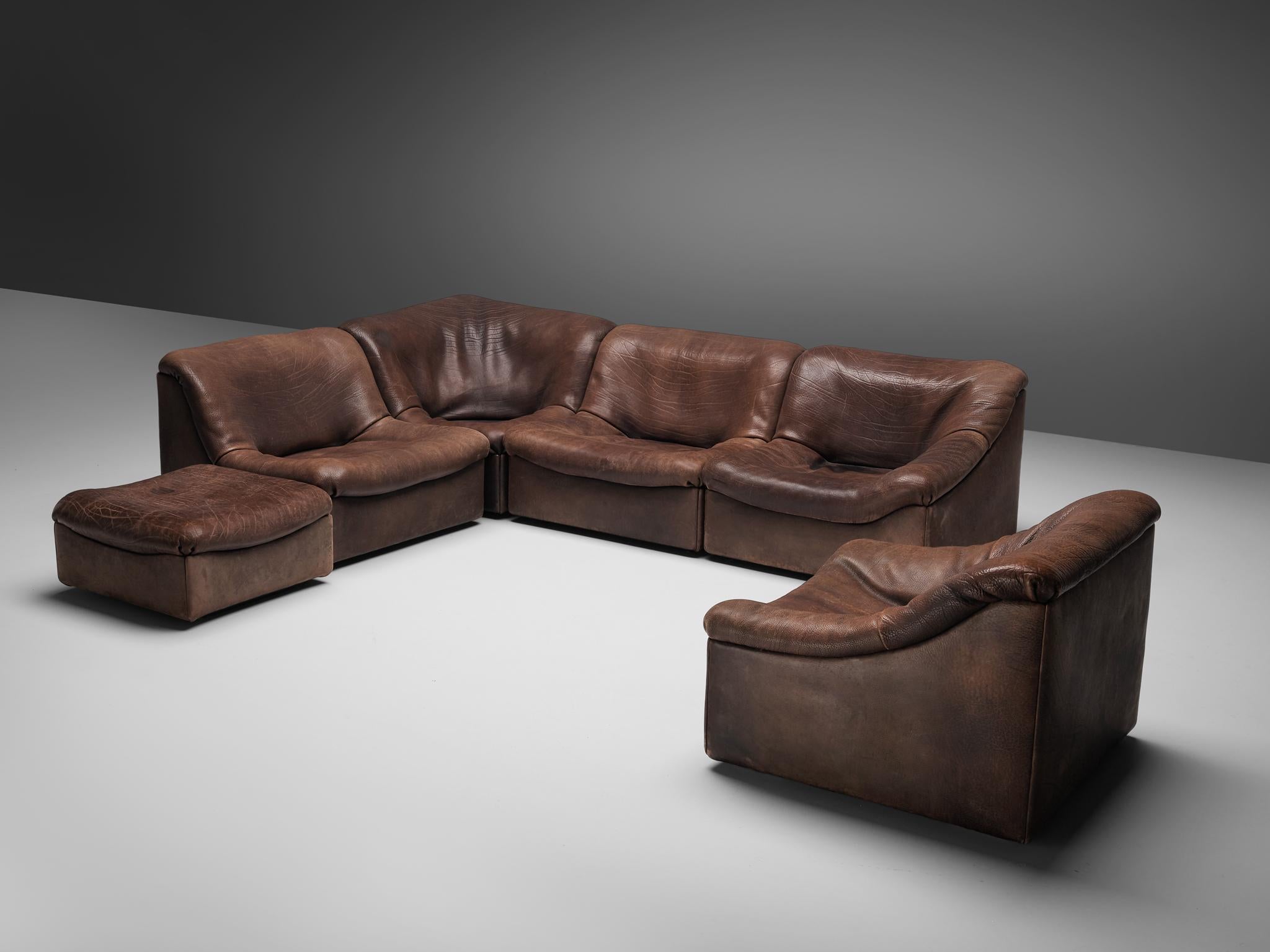 De Sede, DS46 sectional sofa with ottoman, brown buffalo leather, Switzerland, 1970s.

Comfortable six-modular sectional sofa with ottoman in thick buffalo leather by DeSede. This model features a solid base with a rounded, bulky seat and a high