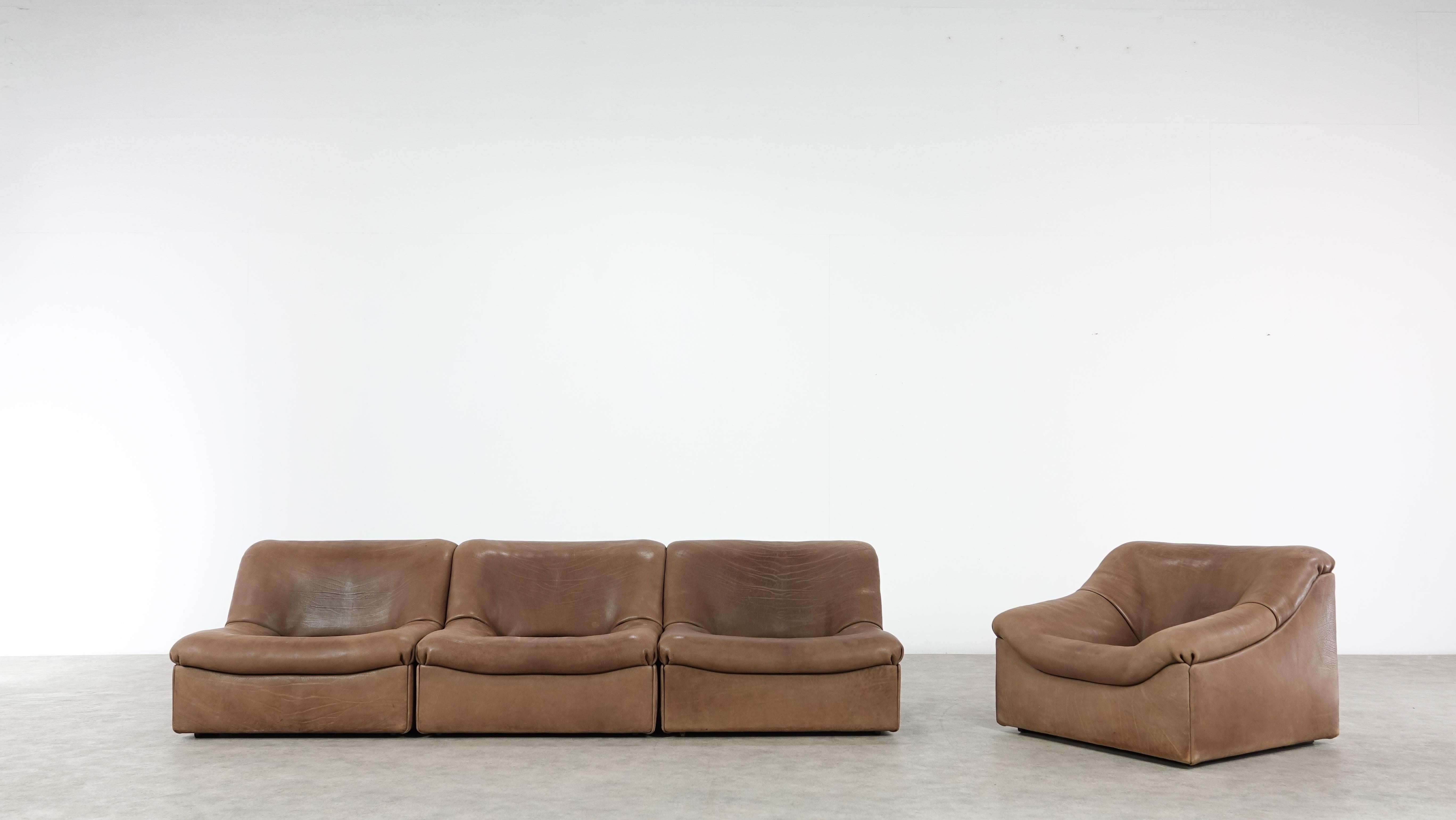 Cognac colored original De Sede DS designer leather corner sofa and one easychair in a minimalistic and modern design, with a convenient modular function, made for pure comfort and flexibility.