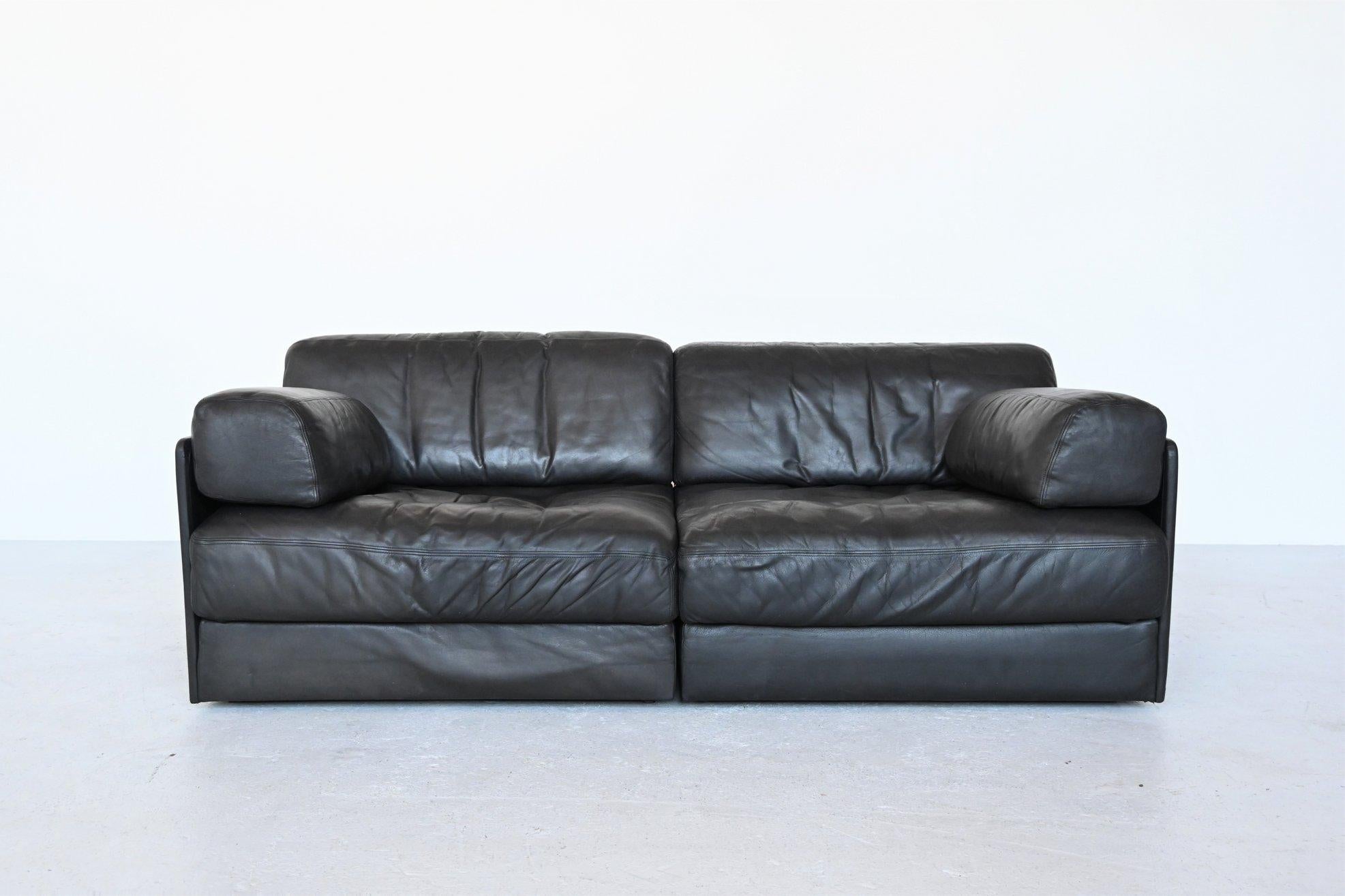 Very comfortable and multi-functional DS76 two-seat sofa designed and manufactured by De Sede, Switzerland 1970. This sofa is made of high quality black leather and finished by hand with high levels of craftsmanship and eye for detail. De Sede is