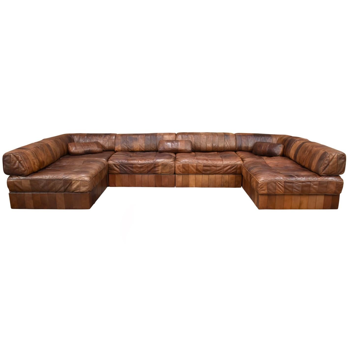Six element DS88 patchwork sofa by De Sede. The sofa has six sections that can be set-up in different ways. Absolutely gorgeous patinated tan, cognac, chocolate brown color aniline leather. In good and completely original condition. 

– 6 elements