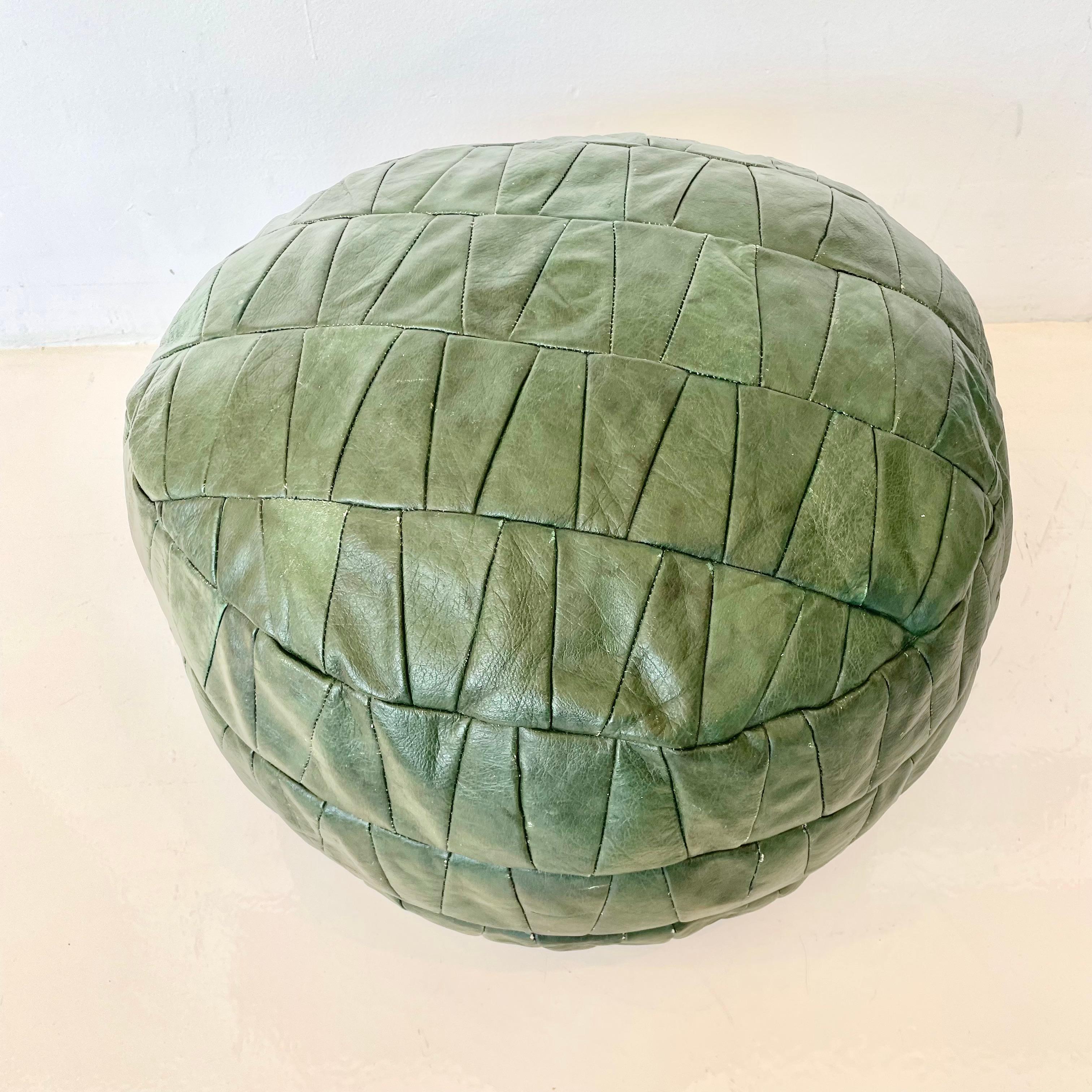 Gorgeous green leather pouf by Swiss designer De Sede. Triangular patchwork design. Great vintage condition. Perfect accent piece. 

