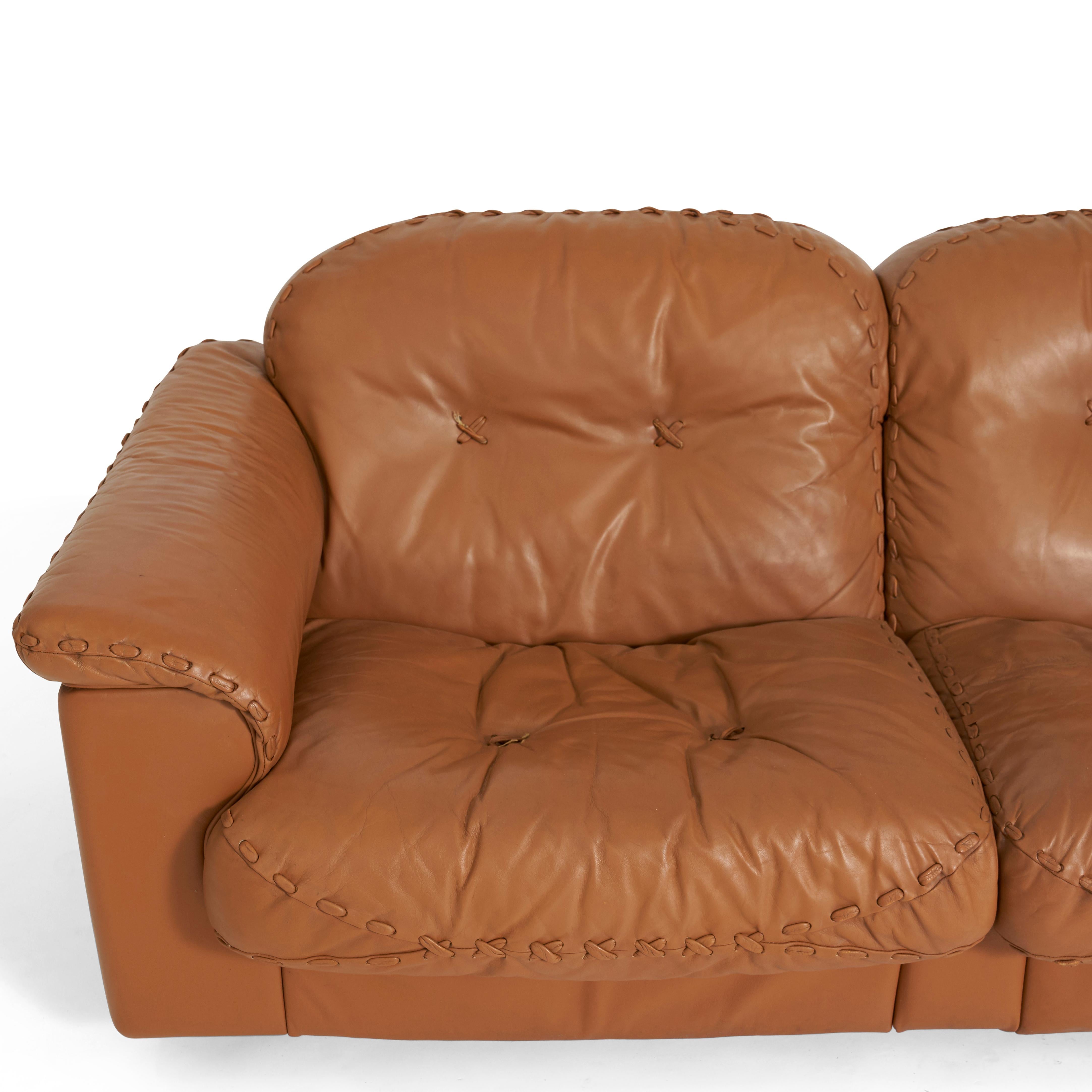 3-seat leather sofa with baseball glove stitching detail at seems. Switzerland, 1960s, by De Sede using some of the finest leather available. Seats extend forward to reclining position.

 