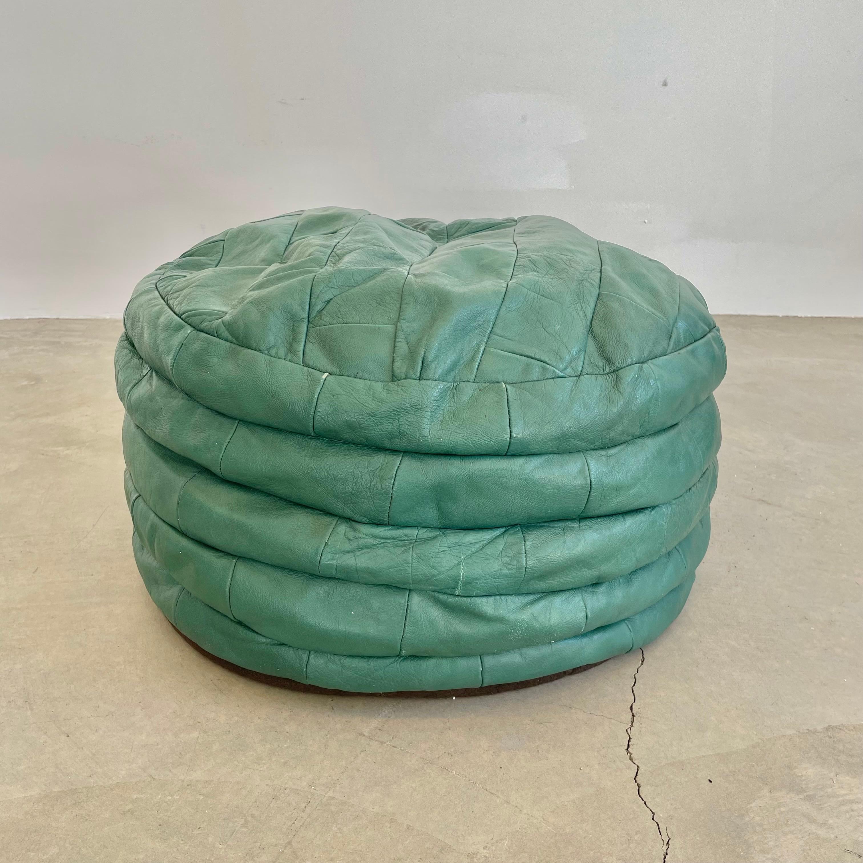 Stunning mint green leather pouf/ottoman by Swiss designer De Sede with square patchwork. Handmade with wonderful light patina. Gorgeous accent piece. Good vintage condition with soft supple leather. Brand new filler. Unusual color. Perfect living