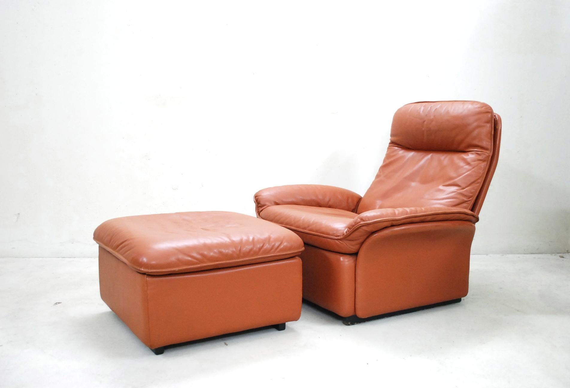 De Sede Model DS 49
This armchair and ottoman was produced in Switzerland by De Sede and is made of cognac brandy aniline leather.
It has a great comfort and an adjustable backrest.

Dimensions:
Armchair
Width 80 cm
Depth 85 cm
Height 82