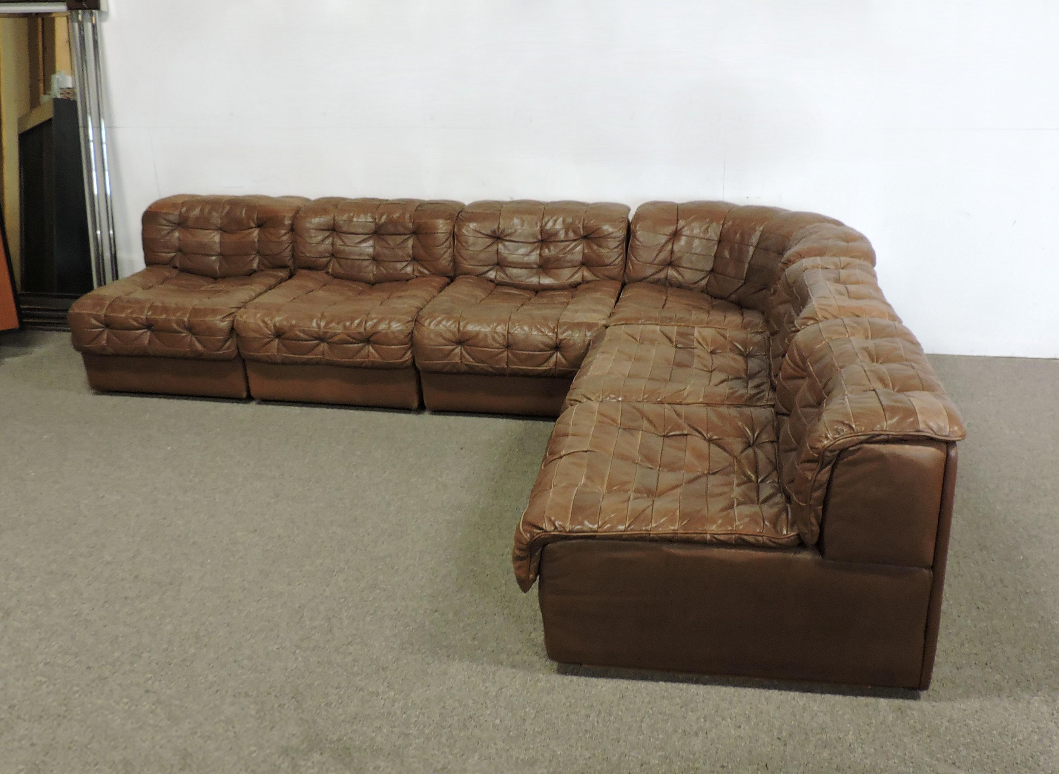 Sophisticated and cozy looking modular leather sofa by high quality manufacturer De Sede of Switzerland. This very comfortable sofa is upholstered in a soft and supple brown leather and consists of six sections, which includes a corner unit, and can