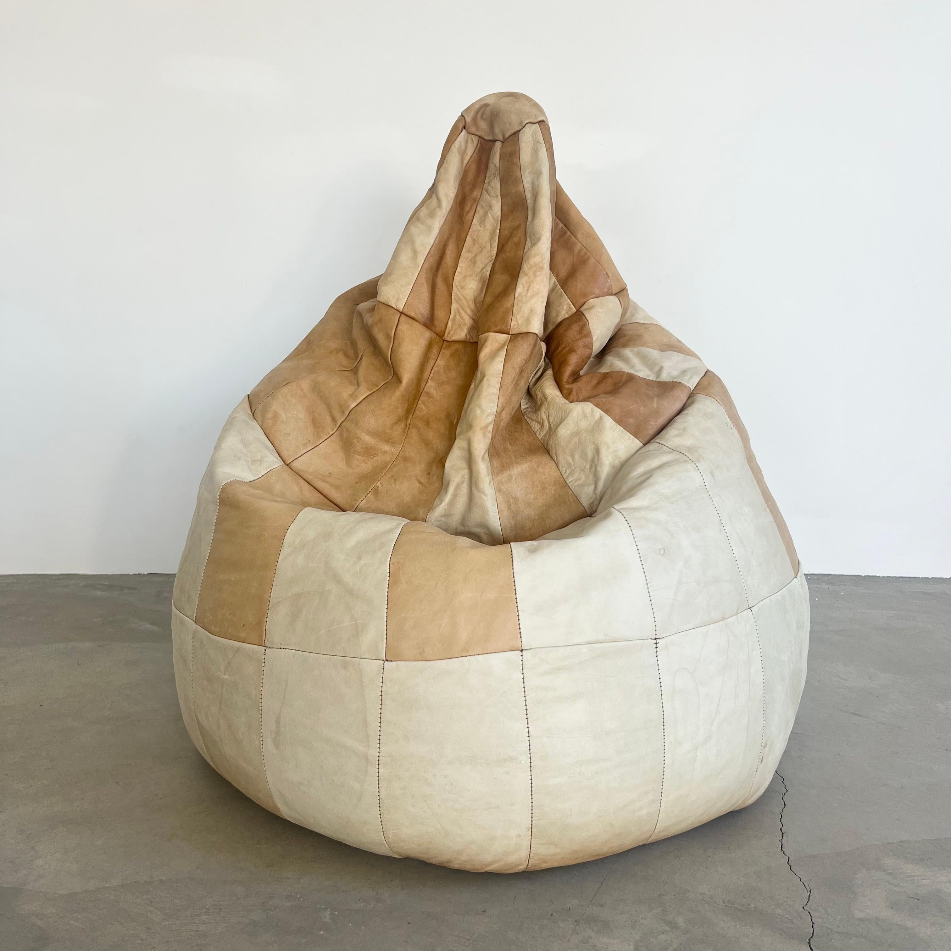 Gorgeous leather patchwork bean bag manufactured by Swiss company De Sede in the 1970s. Wonderful coloring and patina to leather. Multi-color bag with beige, creme and tan leather patchwork. Good condition to leather with some marks and staining as