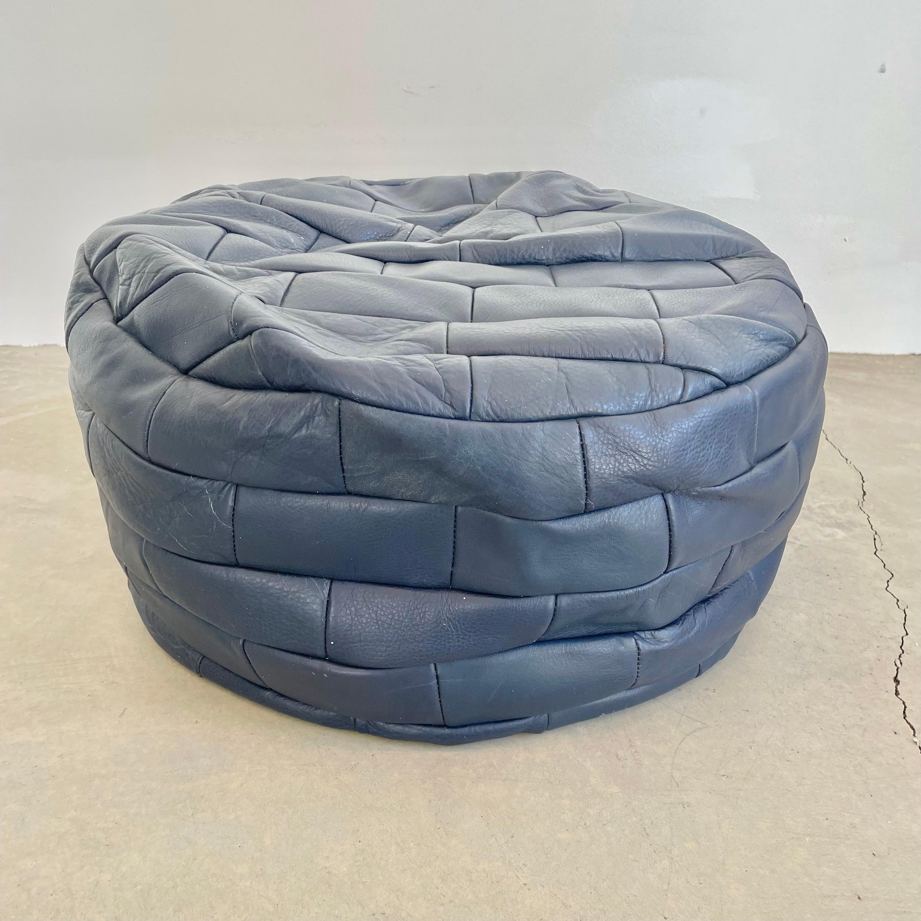 Stunning navy blue leather pouf/ottoman by Swiss designer De Sede with square patchwork. Handmade with wonderful light patina. Gorgeous accent piece. Good vintage condition with soft supple leather. Brand new filler. Perfect living room decor, foot