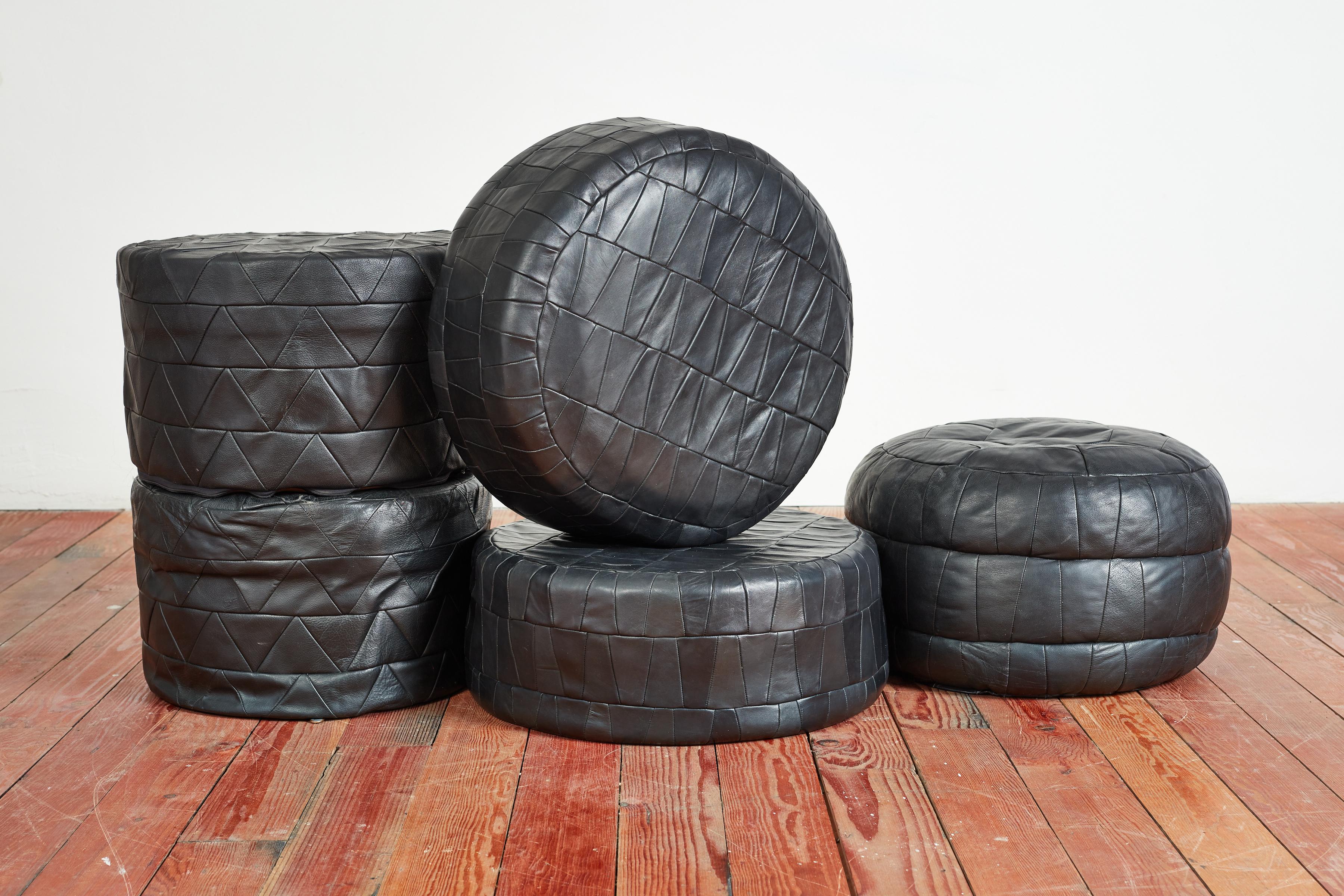 Large collection of patchwork leather ottomans by Swiss designer De Sede. Original soft leather with beautiful patina and age. Multiple colors, sizes and shapes available - inquire for specific details.