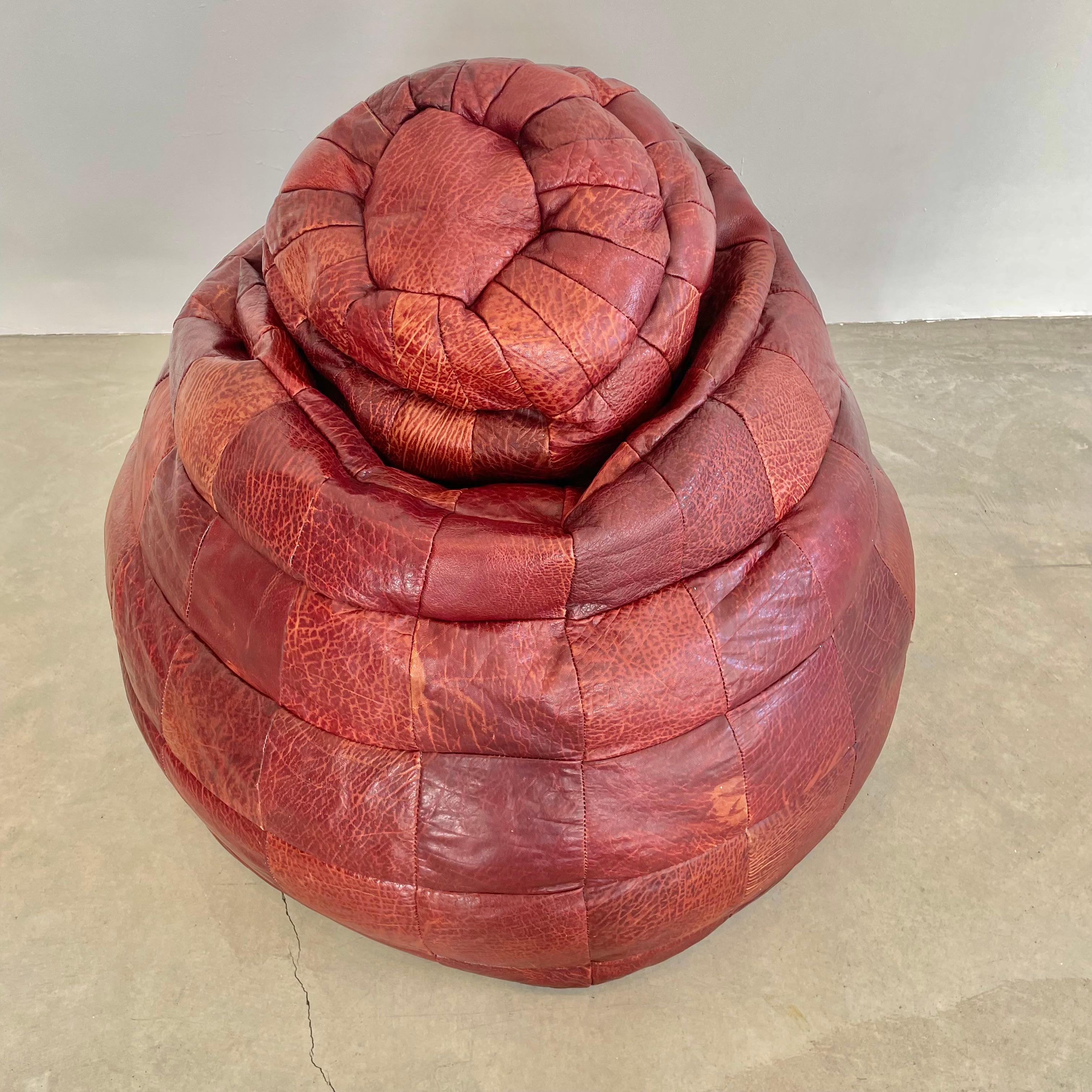 Gorgeous oxblood leather patchwork beanbag manufactured by Swiss company De Sede in the 1970s. Wonderful warm coloring and patina to leather with amazing veining to the leather dye. Some very light scuffs give the bag some life and personality. Good