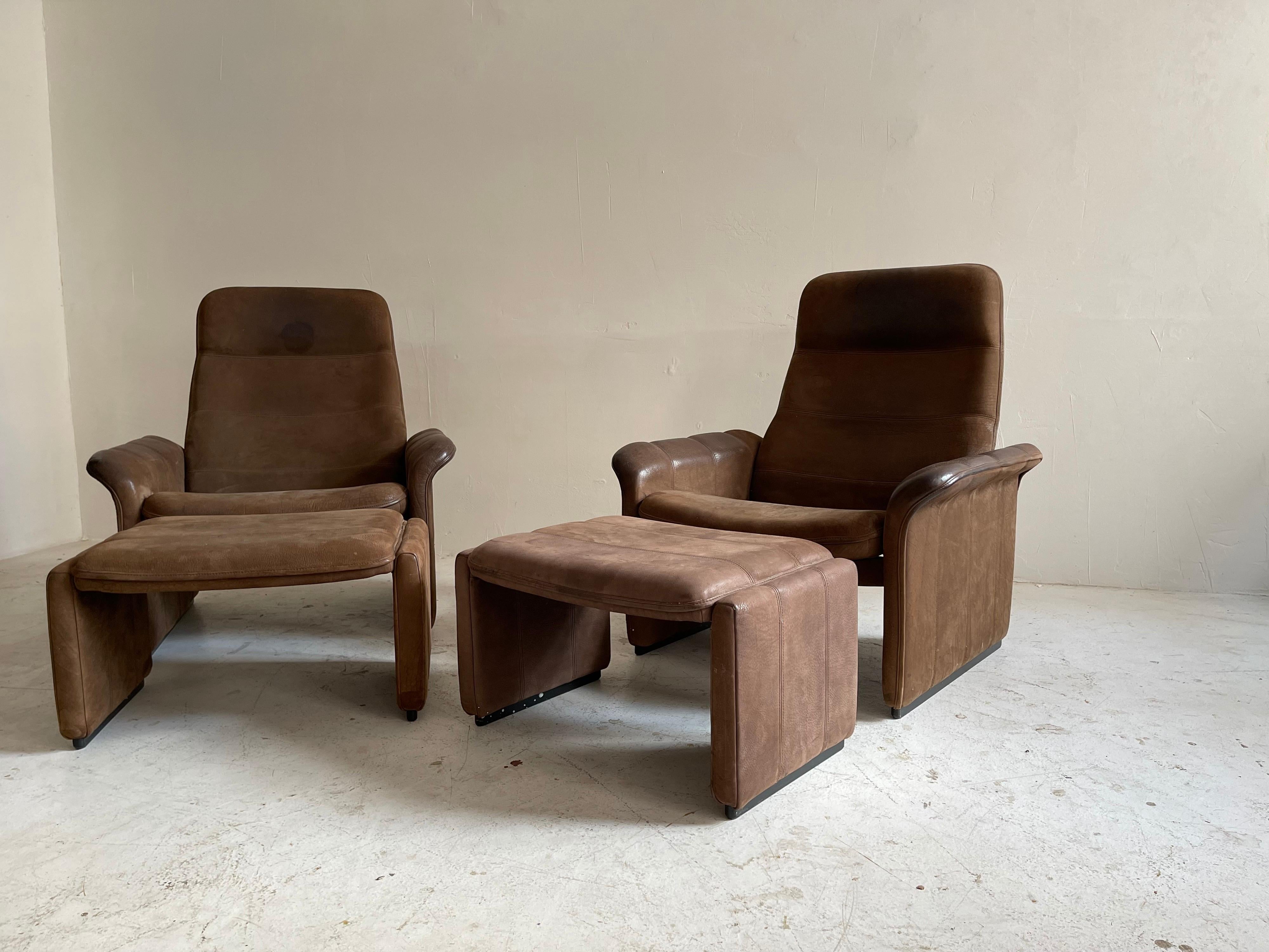 De Sede Pair Patinated Cognac Leather Reclining DS50 Chairs, Switzerland, 1970s. A special and rare find with matching ottomans.