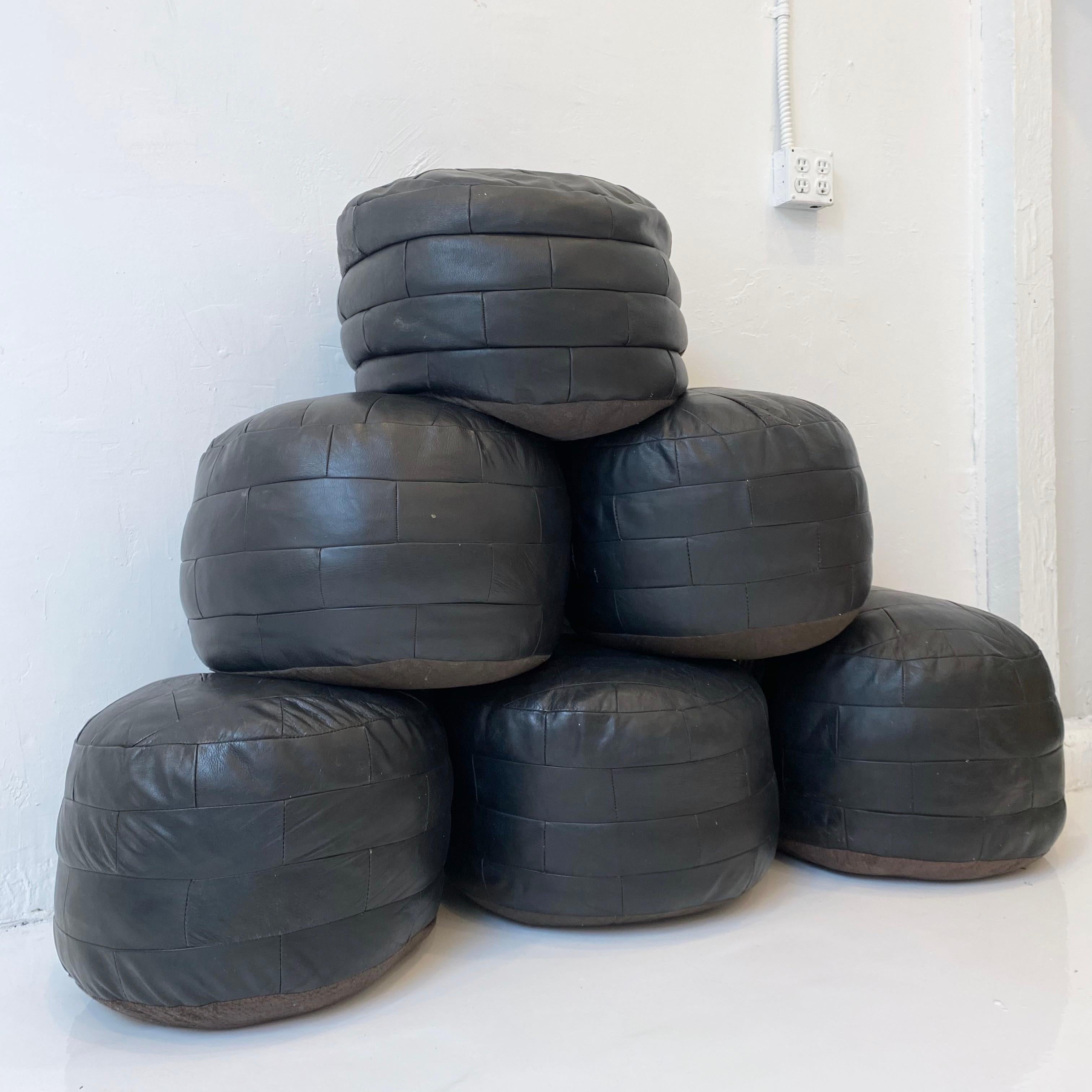 Gorgeous black leather poufs by Swiss designer De Sede with rectangular patchwork. Perfect accent piece. Good vintage condition. 

Six poufs total, priced individually. 
  