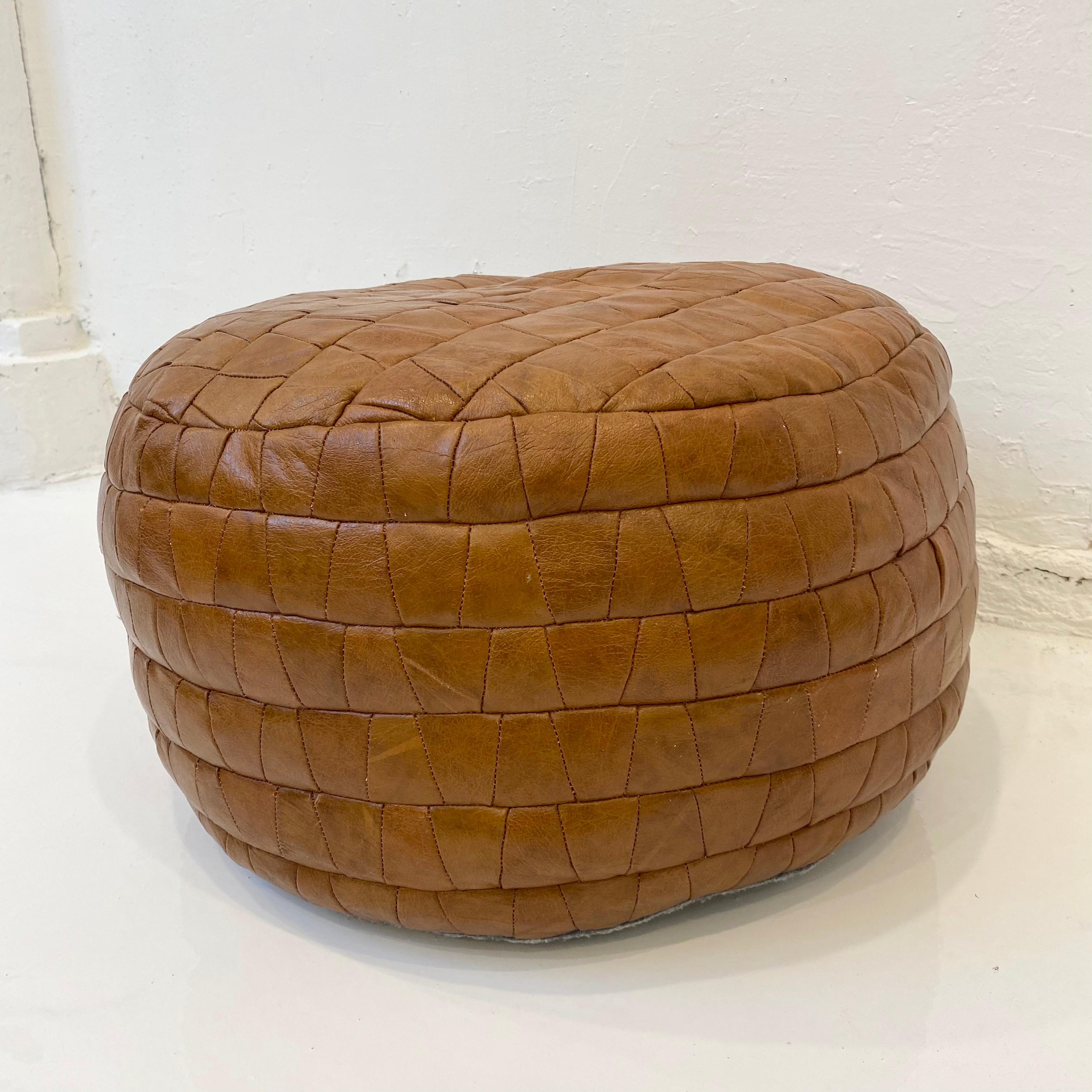 Gorgeous brown leather pouf by Swiss designer De Sede with triangular patchwork. Perfect accent piece. Good vintage condition. 

 