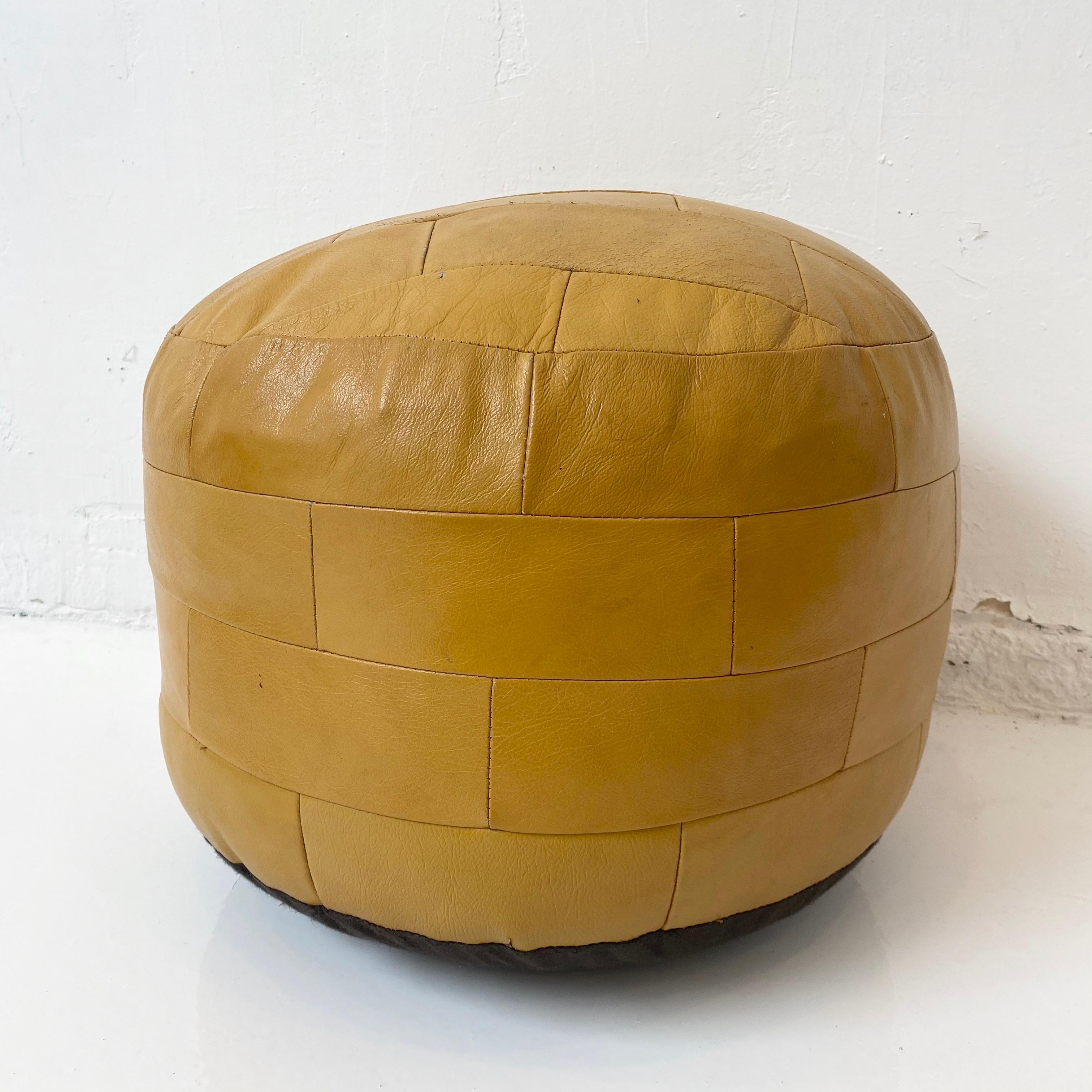 Gorgeous dark yellow leather pouf by Swiss designer De Sede with rectangular patchwork. Perfect accent piece. Good vintage condition. 

 

 