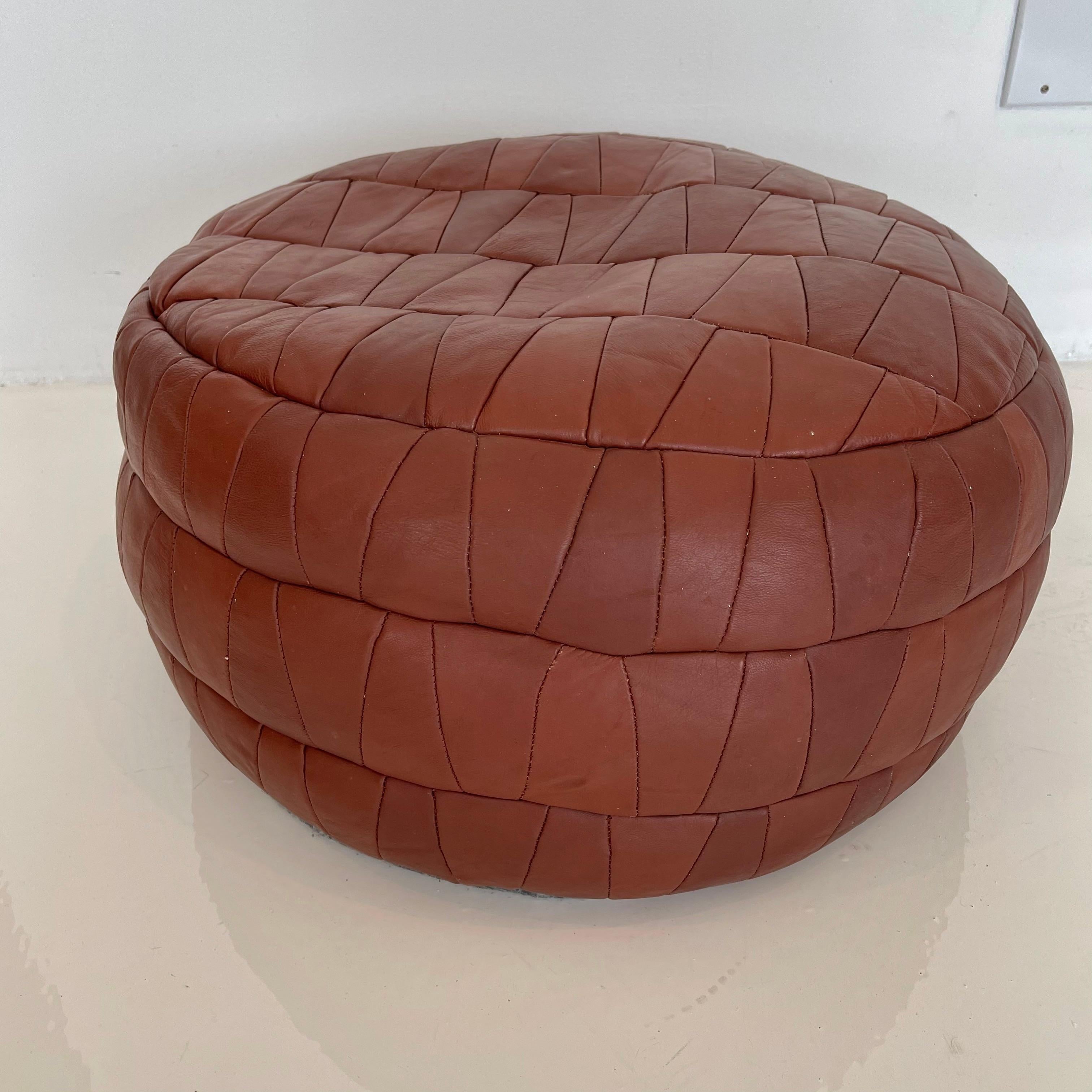 Gorgeous whiskey leather poufs by Swiss designer De Sede. Triangular patchwork design. Great vintage condition. Perfect accent piece. 

Two matching available. Priced individually.