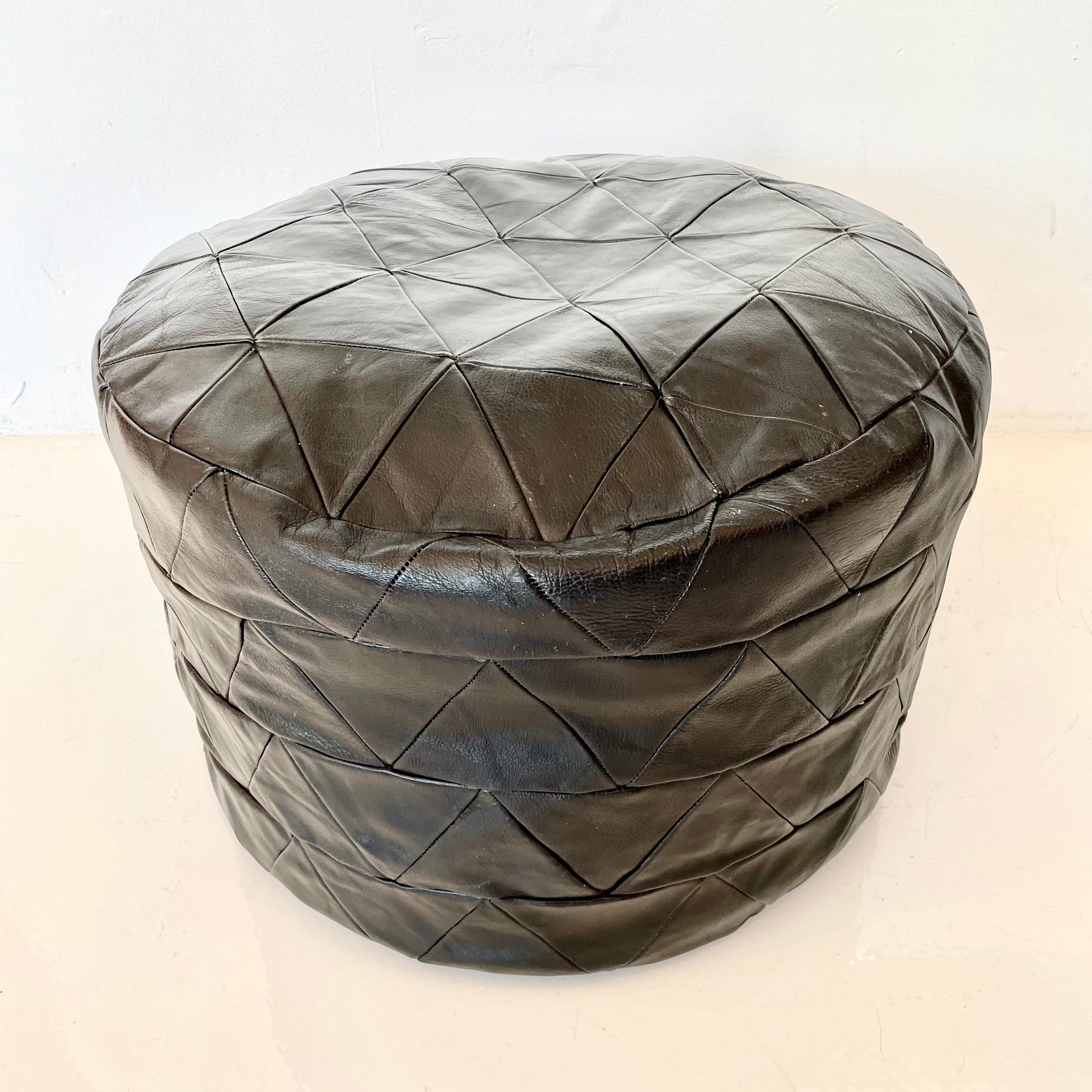 Gorgeous pari of black leather poufs by Swiss designer De Sede. Triangular patchwork design. Great vintage condition. Perfect accent piece. 

Priced as a pair.