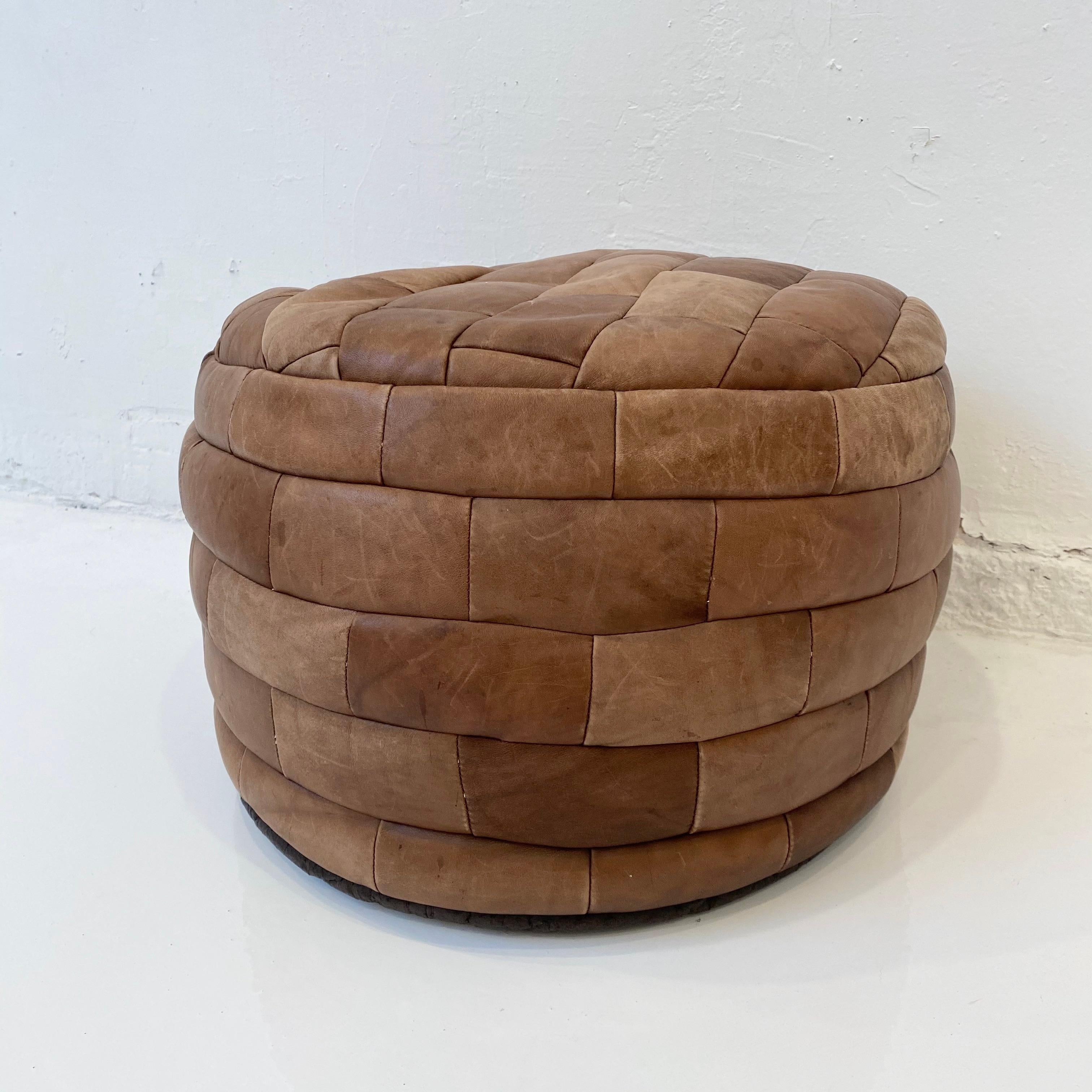 Gorgeous light brown leather pouf by Swiss designer De Sede with rectangular patchwork. Perfect accent piece. Good vintage condition. 

 