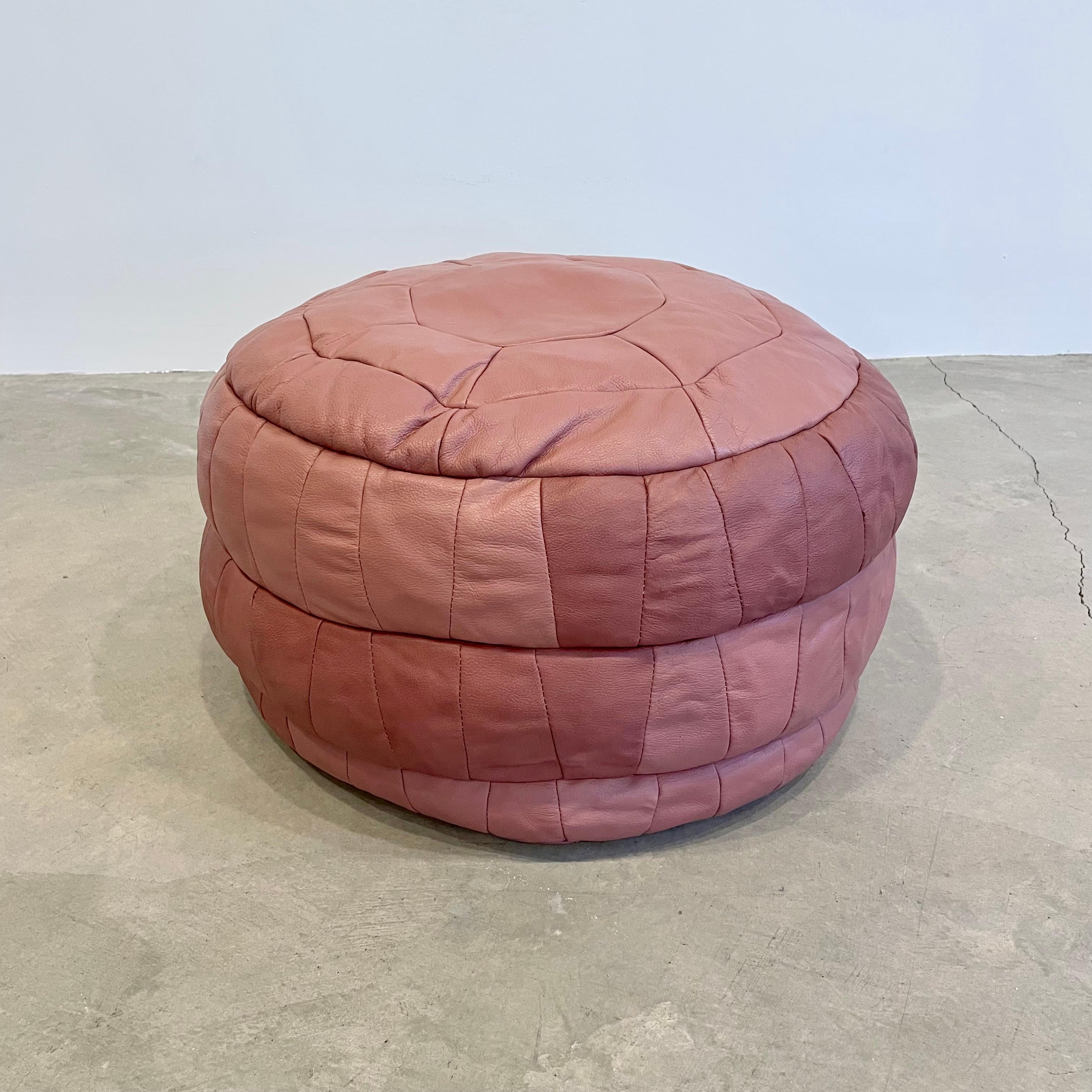 Gorgeous pink rose leather pouf/ottoman by Swiss designer De Sede with square patchwork. Handmade with wonderful faded patina. Gorgeous accent piece. Good vintage condition. Wear appropriate with age. Brand new filler. Perfect living room decor,