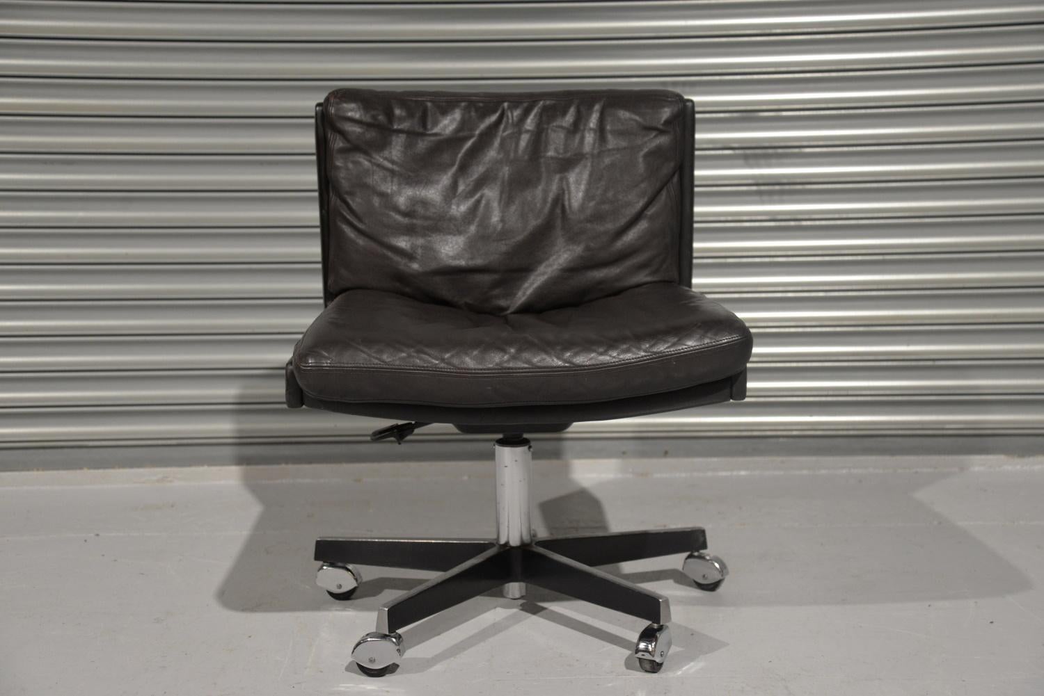 We are delighted to bring to you a highly desirable vintage Robert Haussmann swivel leather desk chair on castors for De Sede. Rarely available and built in the late 1950s by De Sede craftsman in Switzerland, this extremely comfortable armchair is