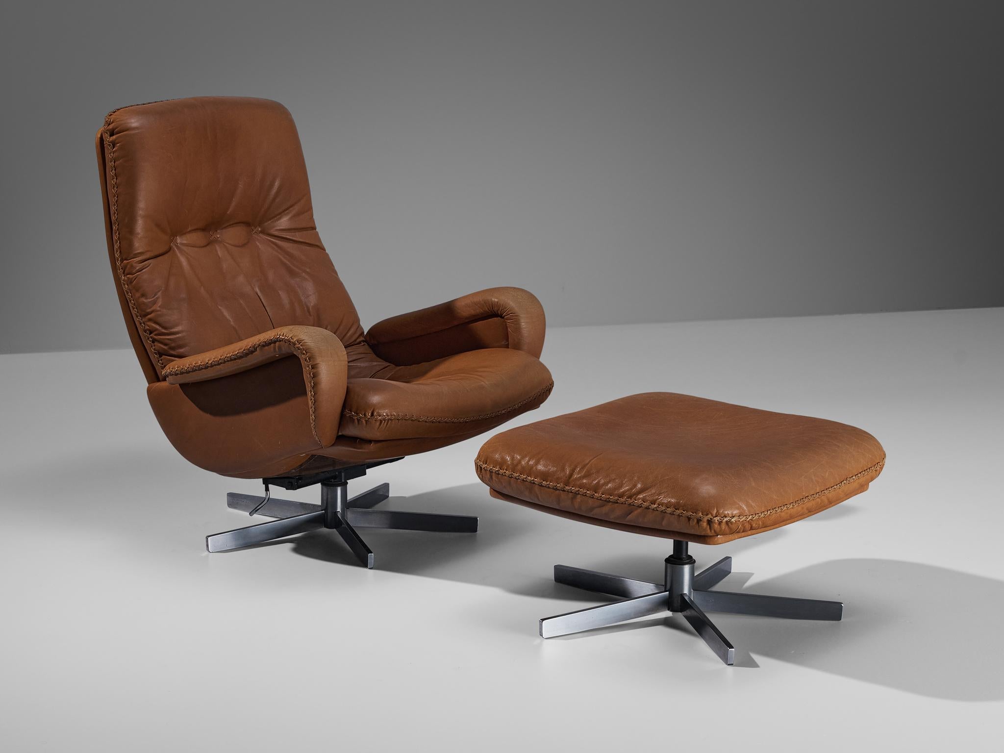 De Sede, set of lounge chair and ottoman, model ''S231'', brown cognac leather, chrome-plated steel, Switzerland, 1960s

This lovely chair by De Sede is based on a solid construction featuring a large backrest and deep seat which offers great