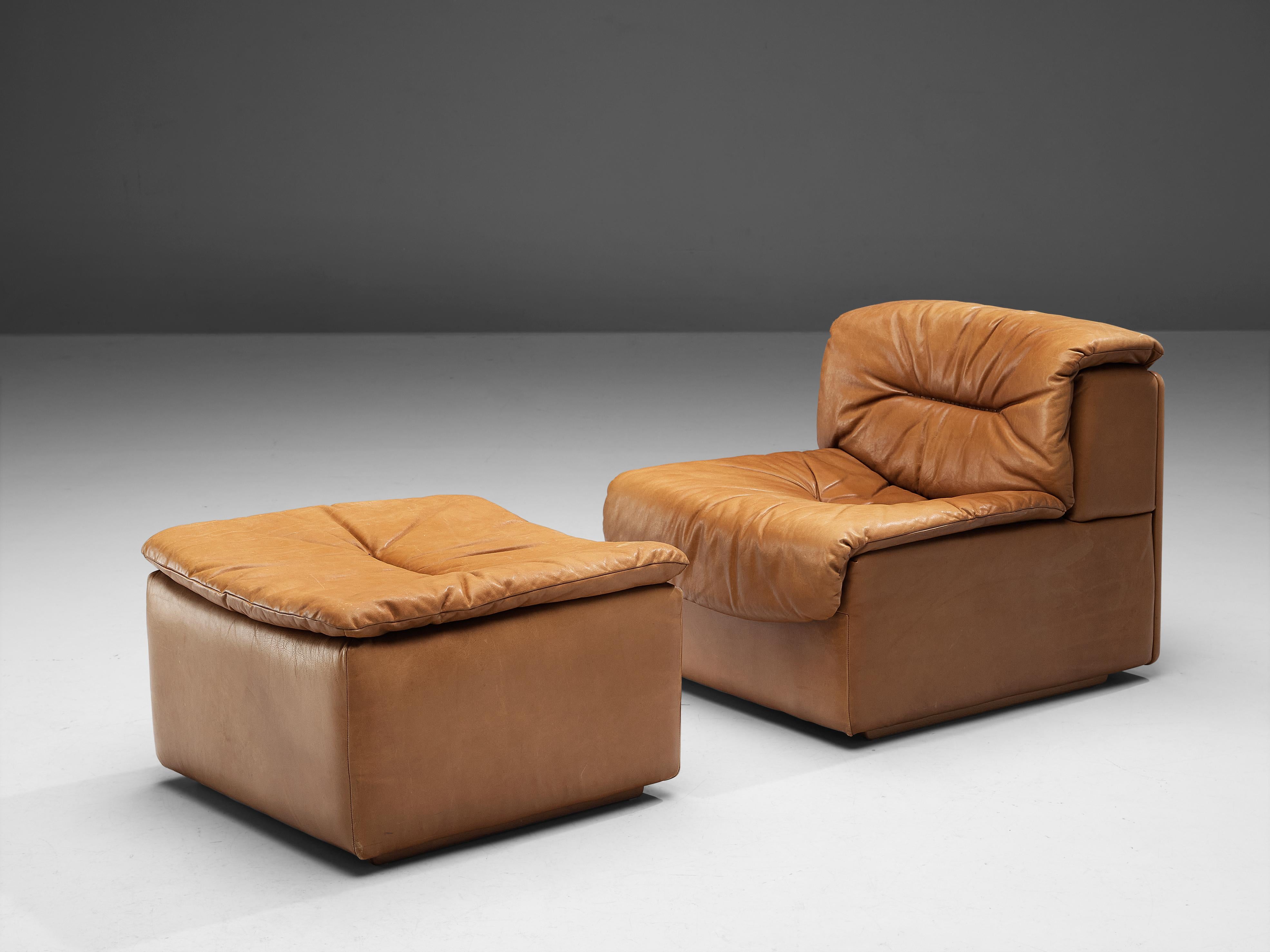 De Sede, settee and ottoman, model 'DS-14', patinated cognac leather, 1970s

This comfortable leather lounge chair and ottoman are made by quality manufacturer De Sede in Switzerland. Known for its craftsmanship, highest quality leather and unique