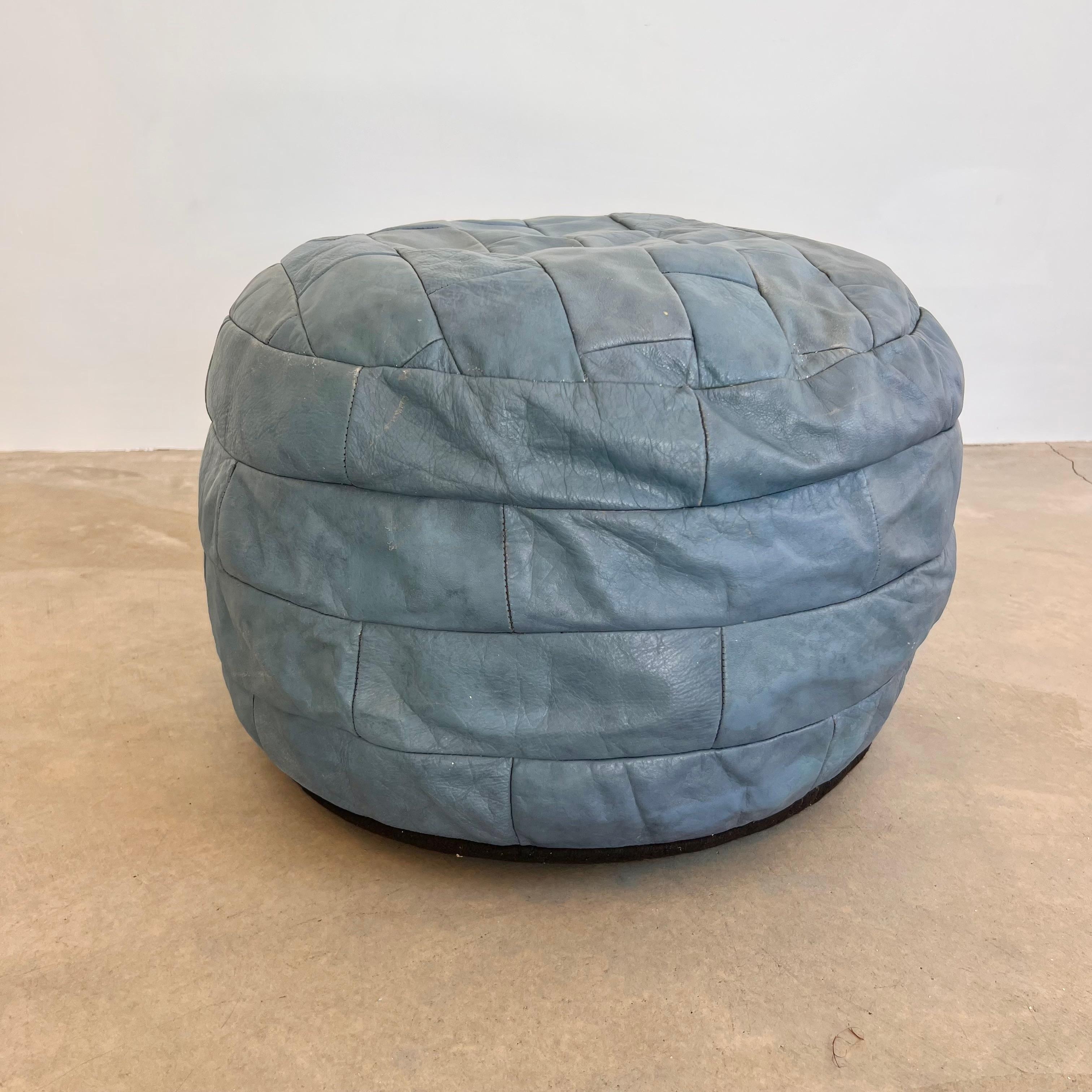 Wonderful slate blue leather pouf/ottoman by Swiss designer De Sede with square patchwork. Handmade with wonderful faded patina or varying hues of blues and greys. Gorgeous accent piece. Good vintage condition. Wear appropriate with age. Brand new