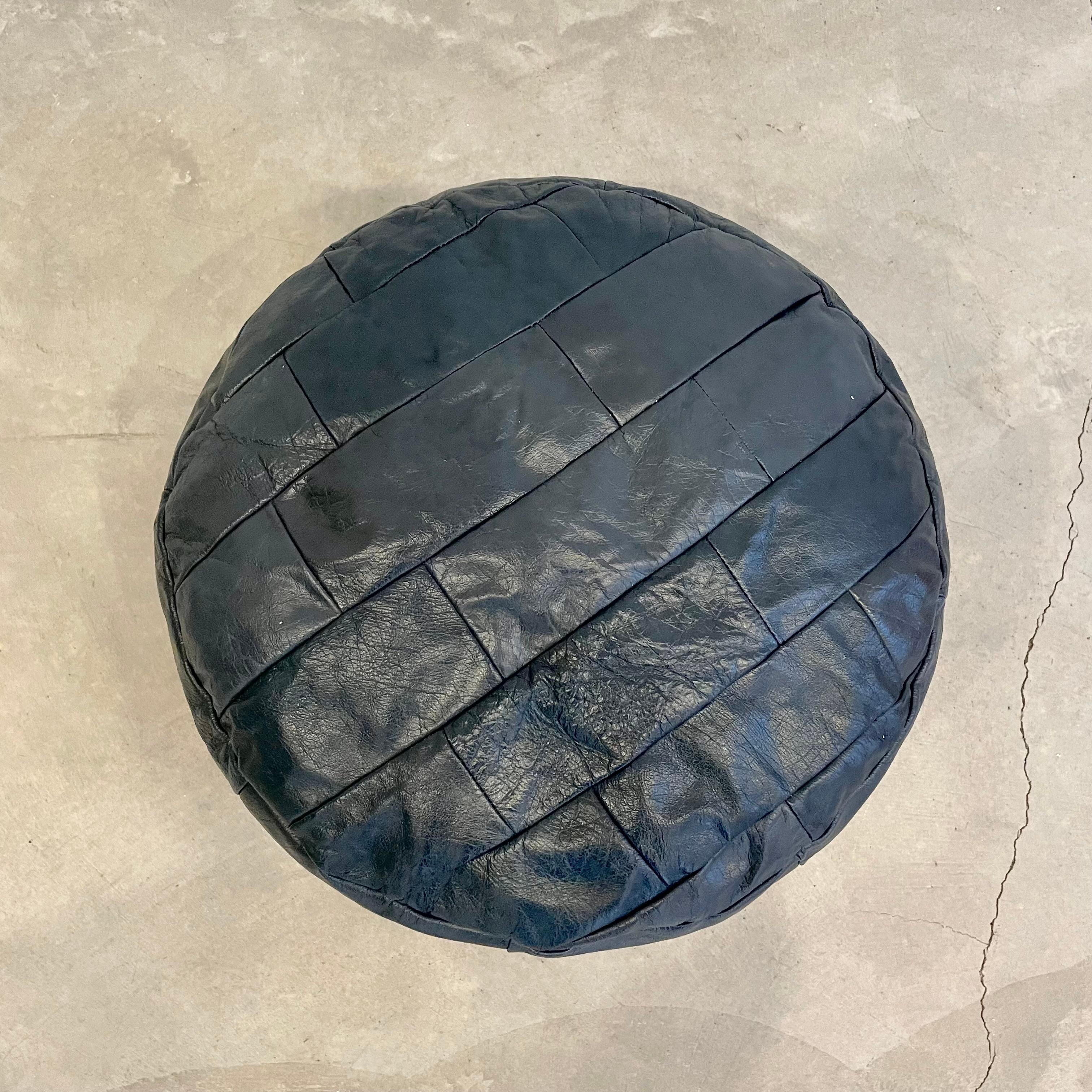 Lovely slate blue leather pouf/ottoman by Swiss designer De Sede with square patchwork. Handmade with wonderful faded patina. Gorgeous accent piece. Good vintage condition. Wear appropriate with age. Newly filled with foam beads. Perfect living room