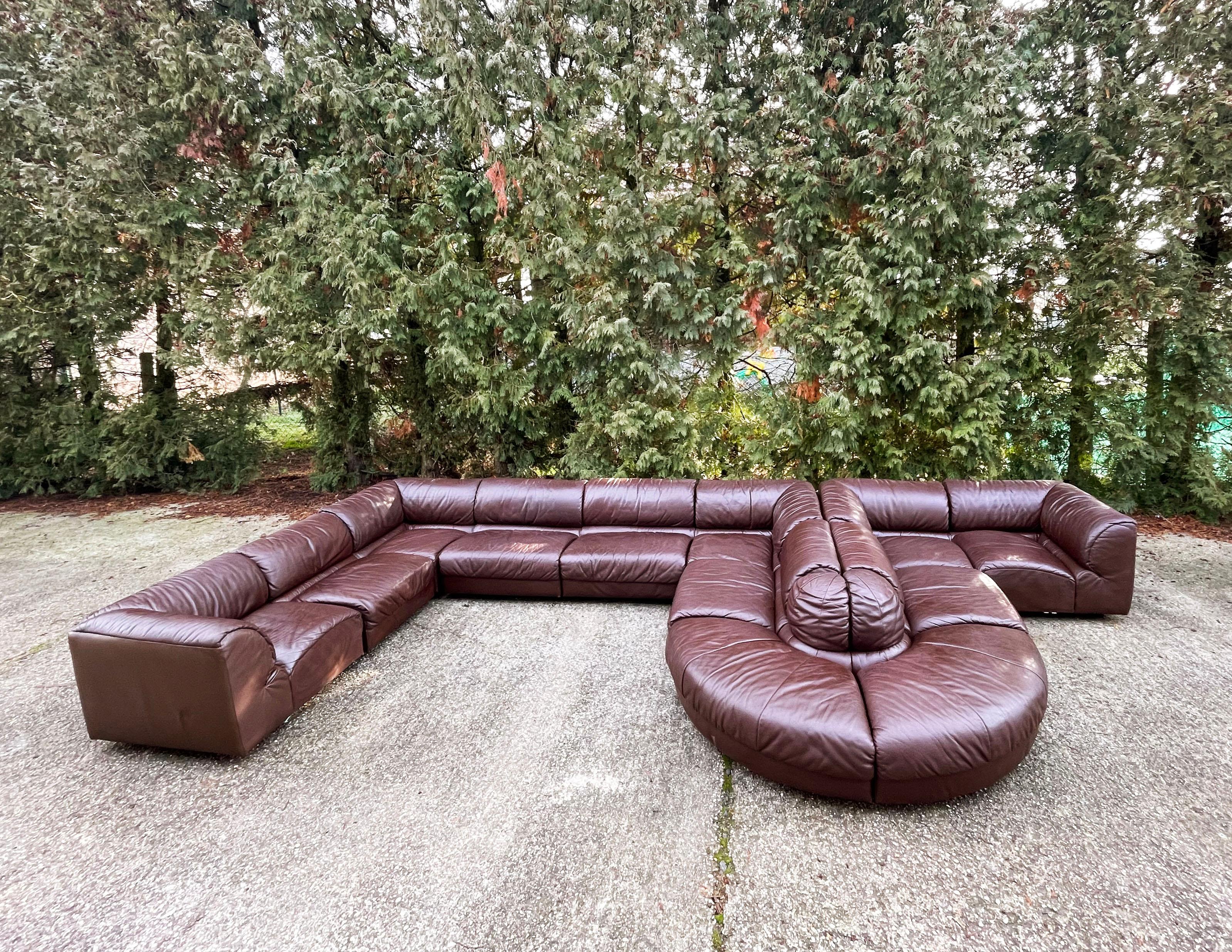 1970s sectional sofa in dark brown leather manufactured by Laauser (the producers label is missing) 

12 modular sections can be arranged in many different shapes or even split into 2-3 smaller sofas 

Upholstered in a very nice thick supple