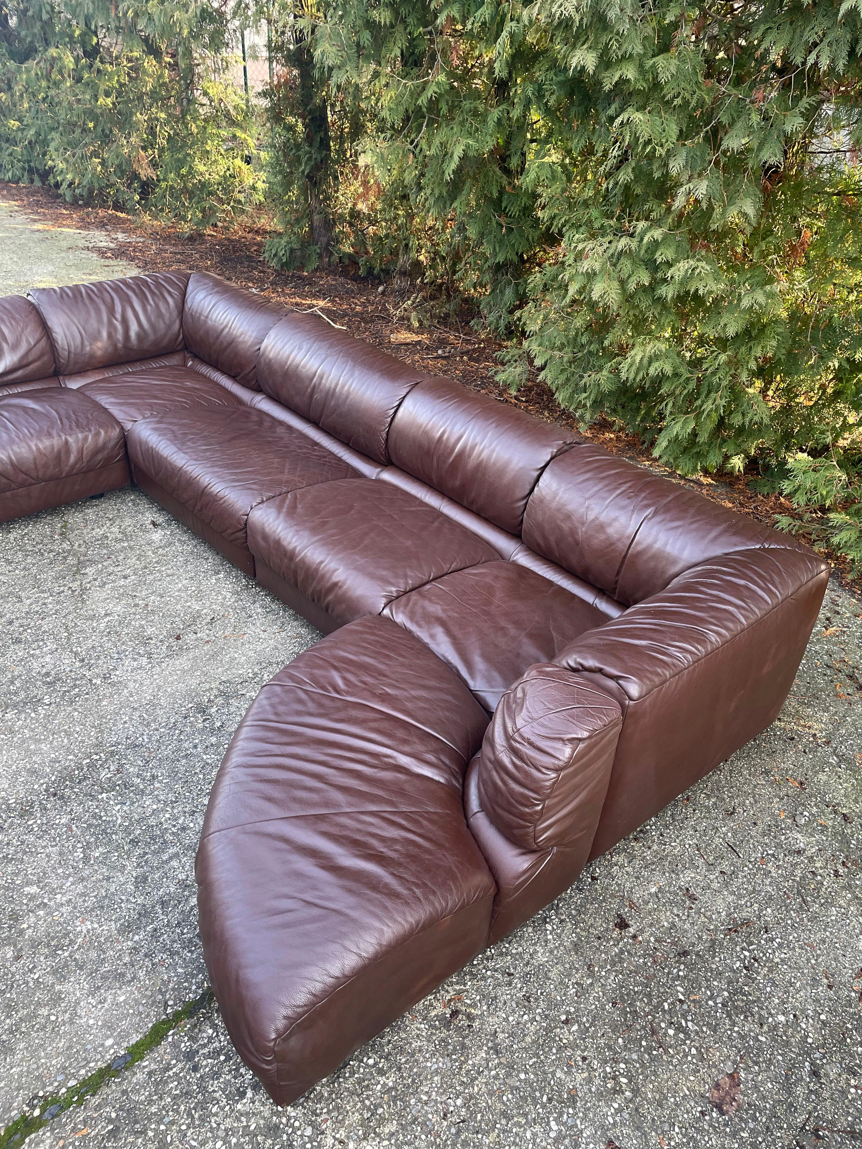 1970s sectional sofa in dark brown leather manufactured by Laauser (the producers label is missing)

7 modular sections can be arranged in many combinations

The sofa is upholstered in a very nice thick supple leather

This sofa is in its