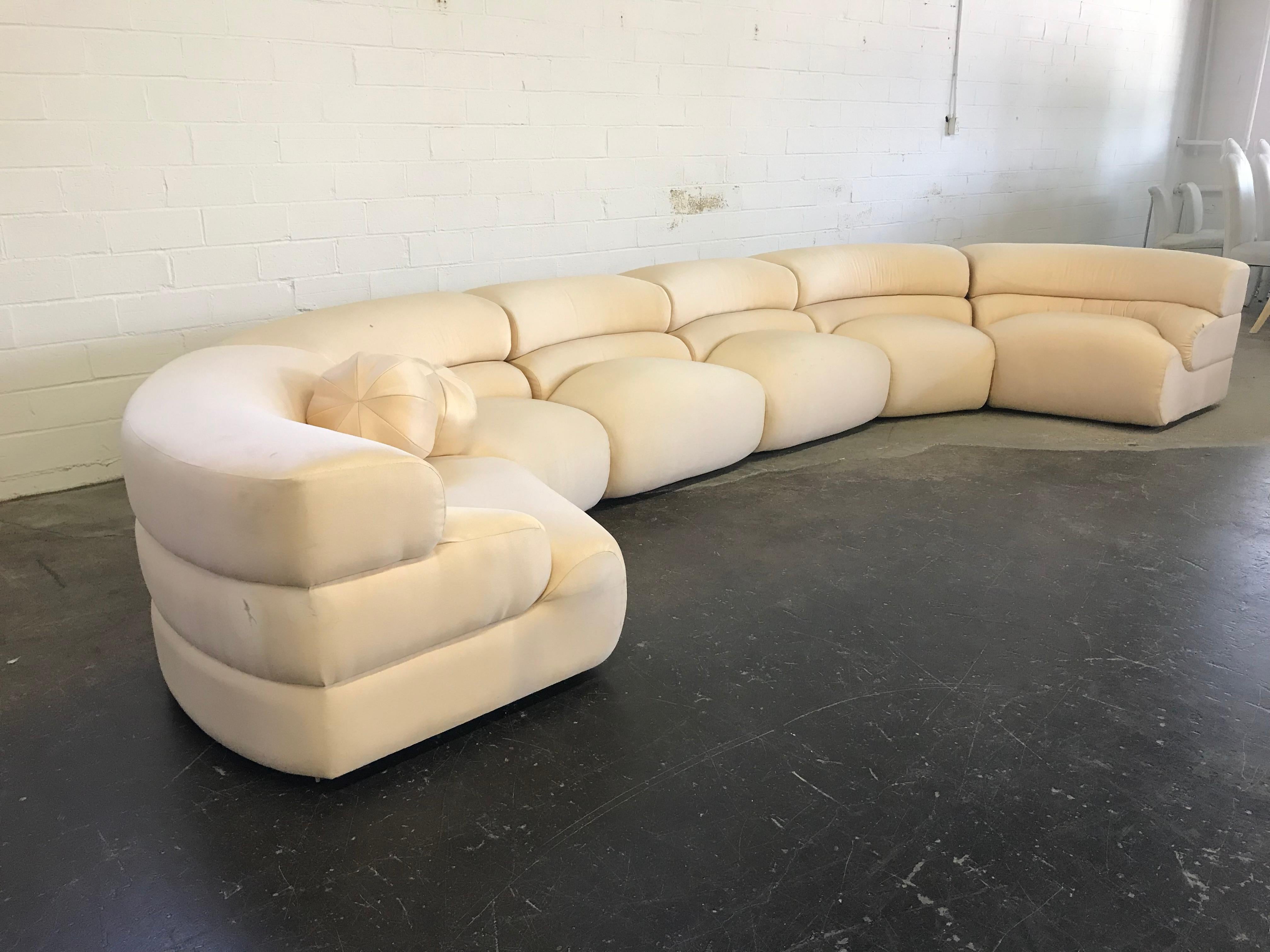 This sectional measures 168 inches in length but can be arranged in more of a semi circle than the curved arrangement show in the pictures. New upholstery recommended.