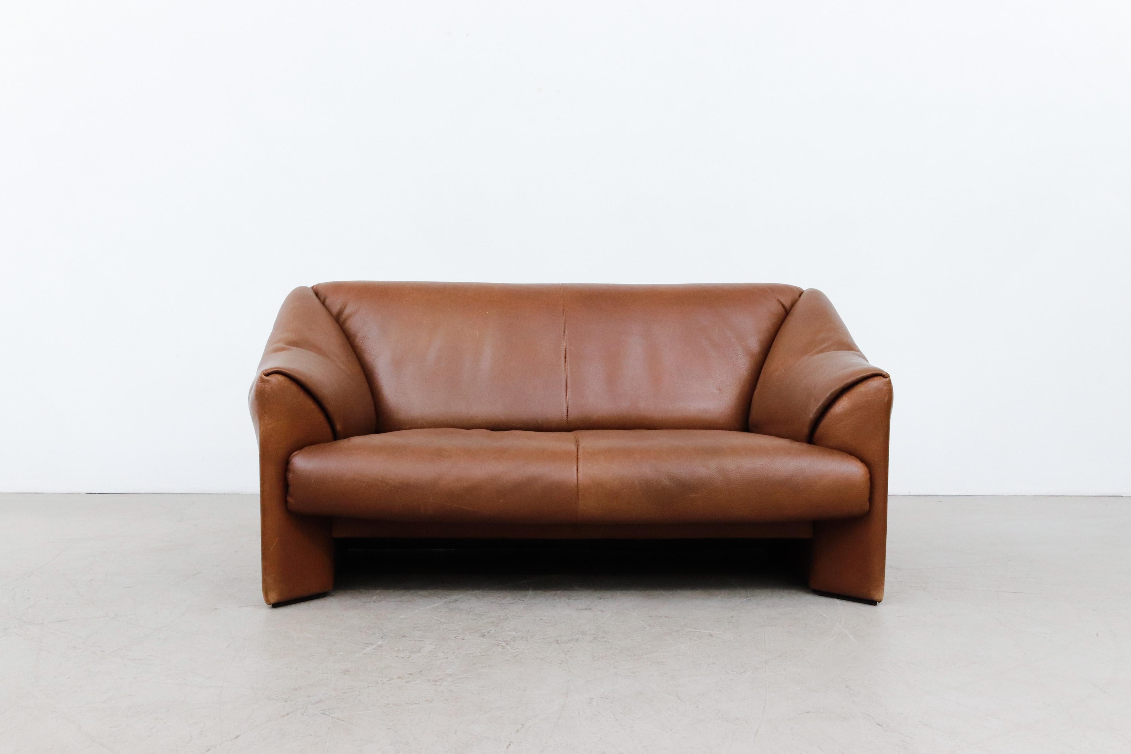 Handsome Leolux Buffalo leather 'DS47' style loveseat in original condition with normal wear and visible patina. Some imprints in leather from transport that should reduce over time. Wear is consistent with its Age and Use.