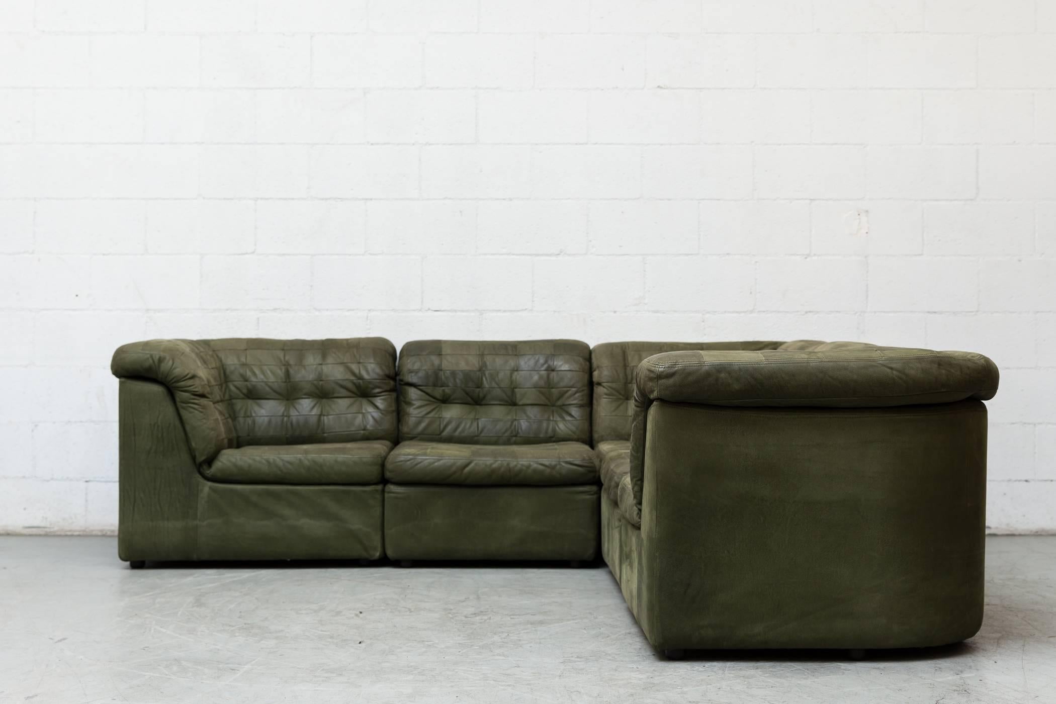 Gorgeous midcentury green patchwork leather four-piece sectional sofa with matching lounge chair. Good original condition with signs of wear consistent with its age and usage.

Measurements: 
Sofa - 96 x 96 x 14.5/29
Chair - 32.5 x 36 x