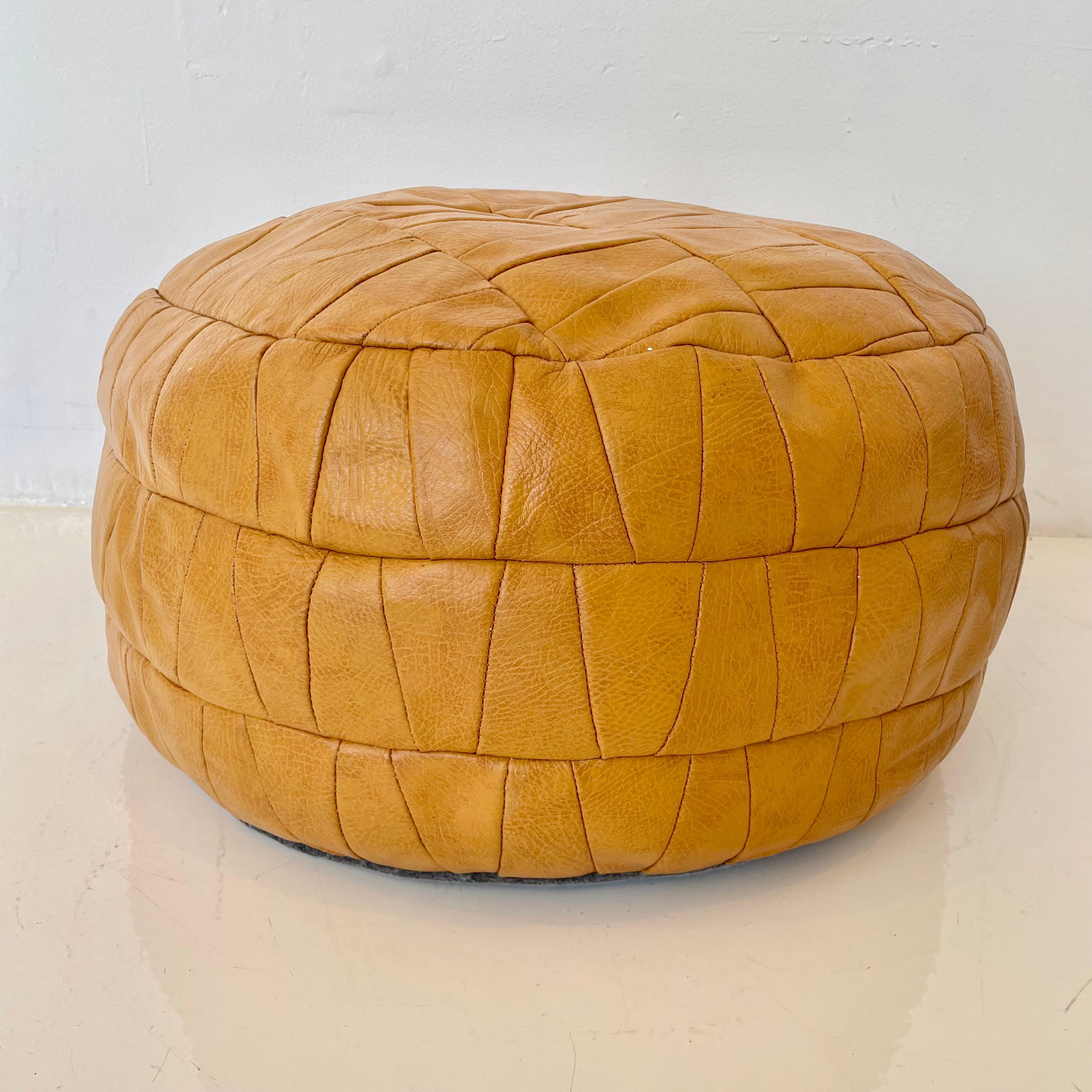 Gorgeous tan leather pouf by Swiss designer De Sede. Triangular patchwork design. Great vintage condition. Perfect accent piece. 

