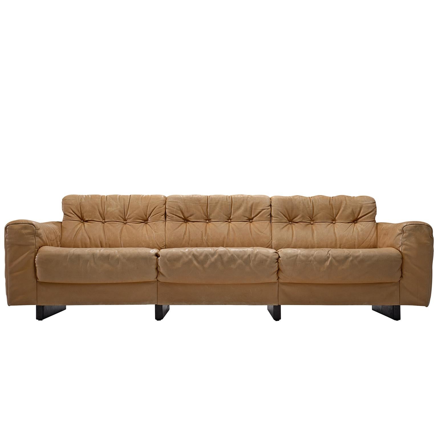 De Sede, three-seat sofa model 'DS-40', cognac leather, Switzerland, 1970s. 

This voluptuous sofa is a true delight to sit in. The thick cushions on armrests, seat and back support the sitter exquisitely. The design of the sofa is grand, bulky and