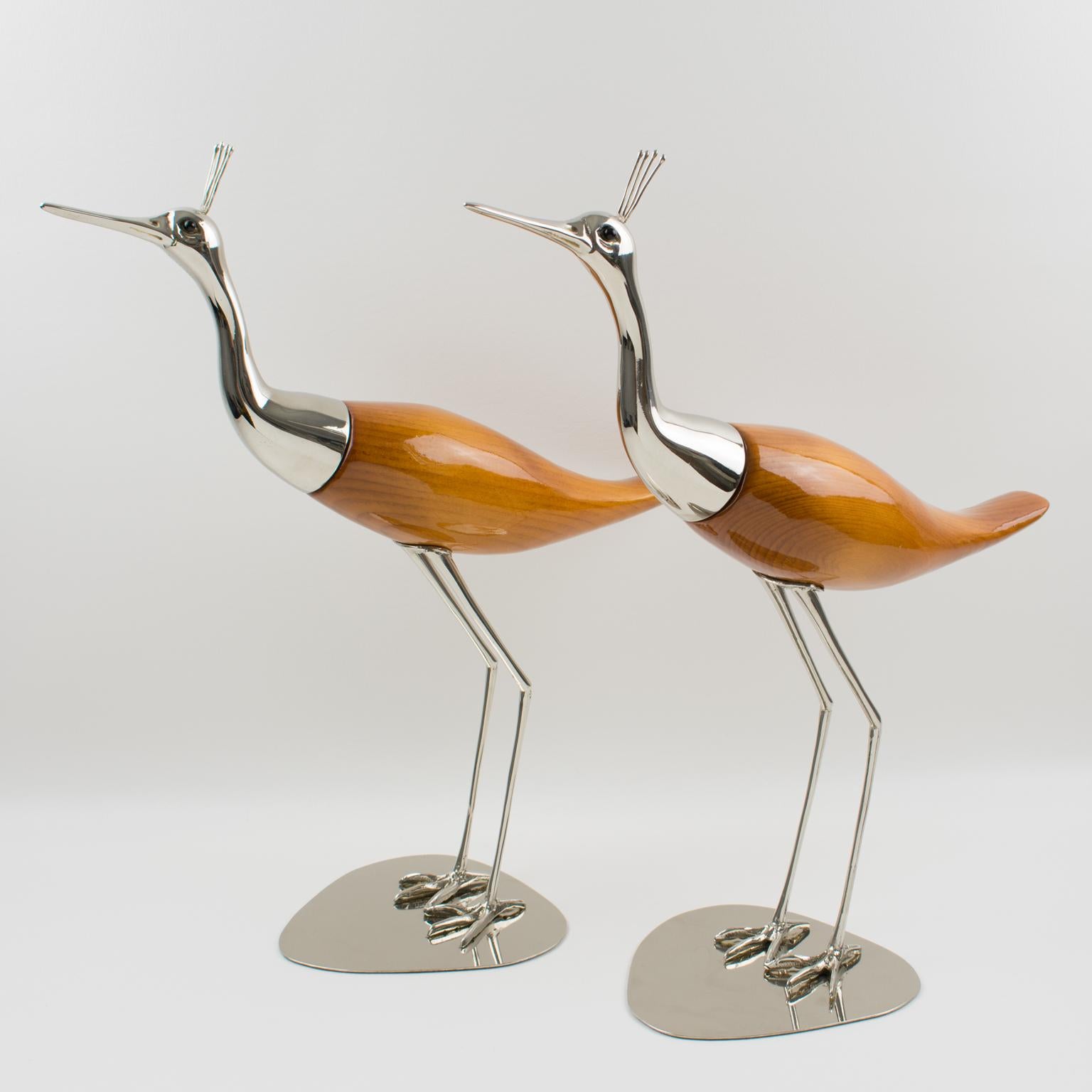 A beautiful pair of large birds, egret or wader, designed and handcrafted by Italian company De Stijl in Firenze. Each bird is carefully crafted with silvered metal and glossy polished lacquered carved wood and has black glass eyes. They have
