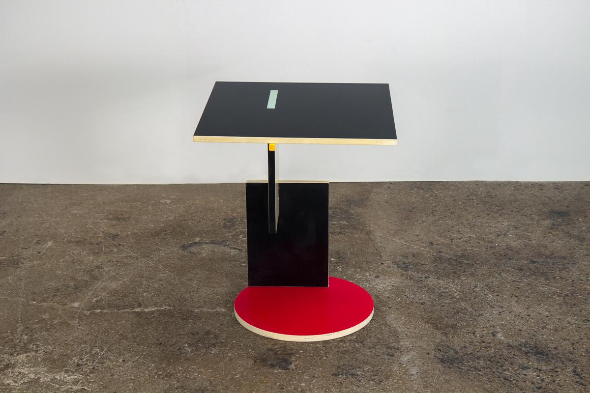 Asymmetrical table by Dutch designer and architect Gerrit Rietveld. Created especially for his 1924 Schroeder House, this lacquered side table embodies the geometric cubist form of De Stijl design. The smooth painted surface is executed in a bright
