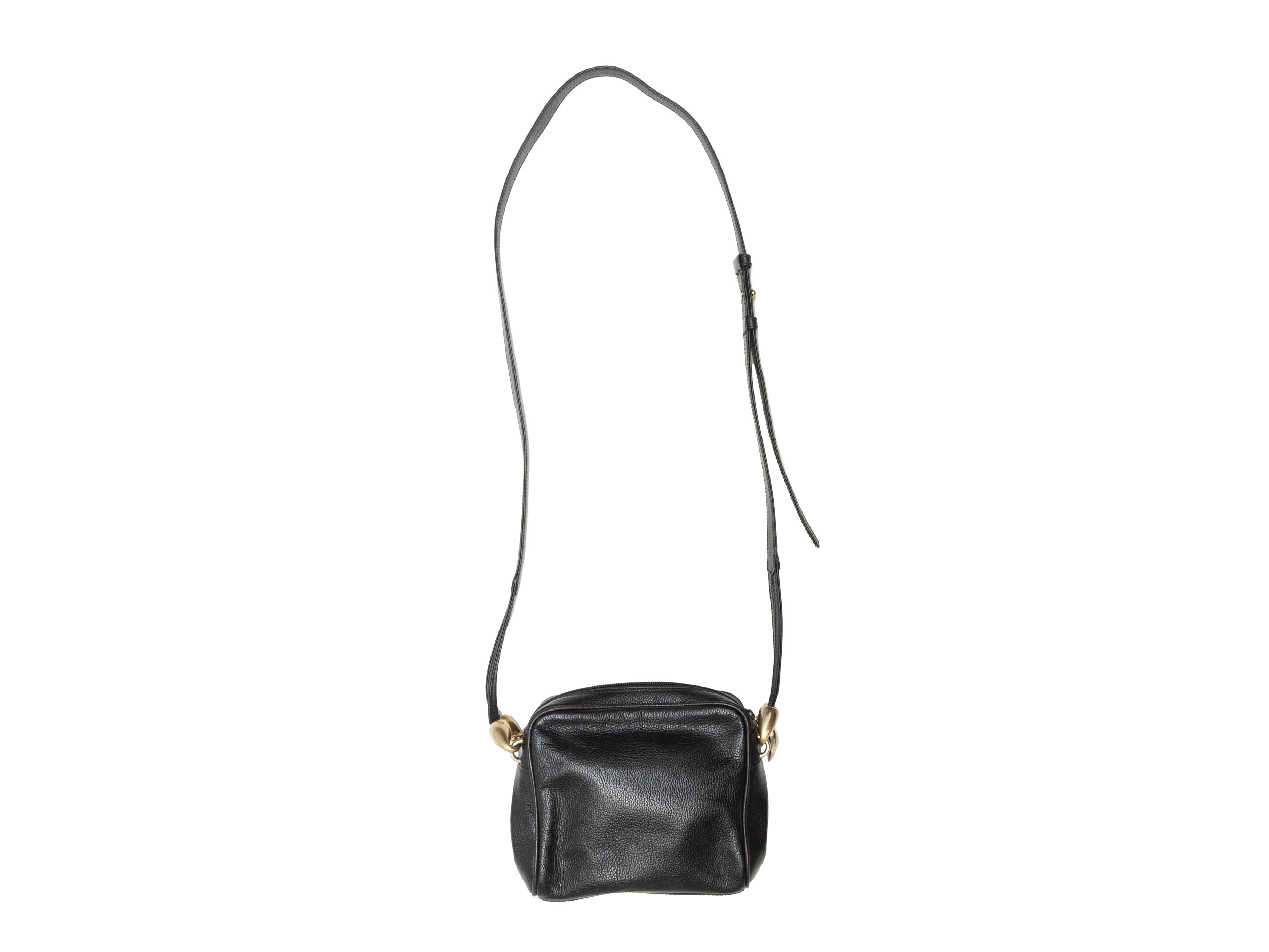Product details: Black leather crossbody bag by De Vecchi by Hamilton Hodge. Gold-tone hardware. Interior zip pocket. Adjustable shoulder strap. Zip closure at top. 7