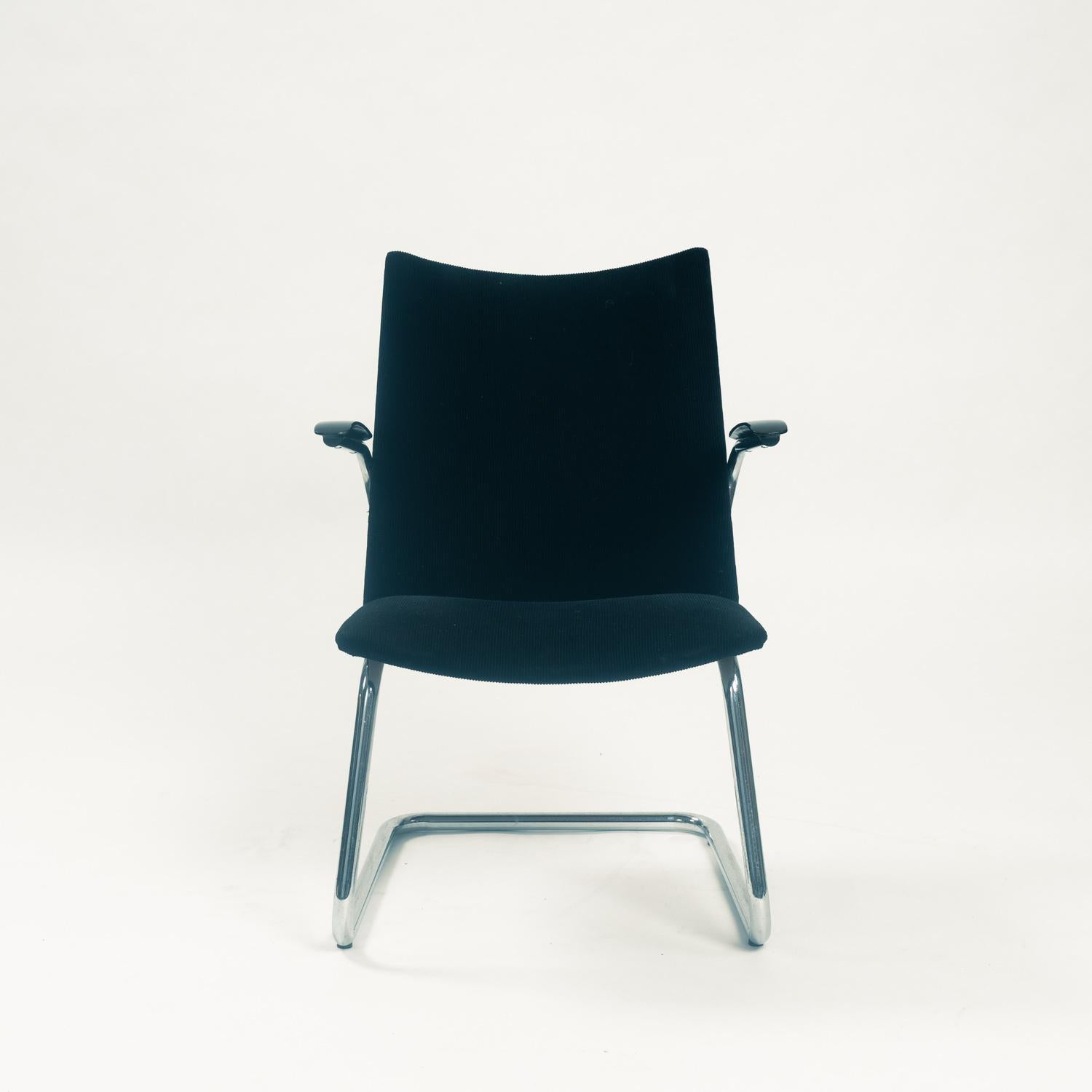 Back-leg less de Wit armchair in tubular steel and black teddy fabric  designed by Toon de Wit in the 1950s.

These chairs by de Wit are very compact and very comfortable.

The seat and backrest are origiginally upholstered with black manchester rib