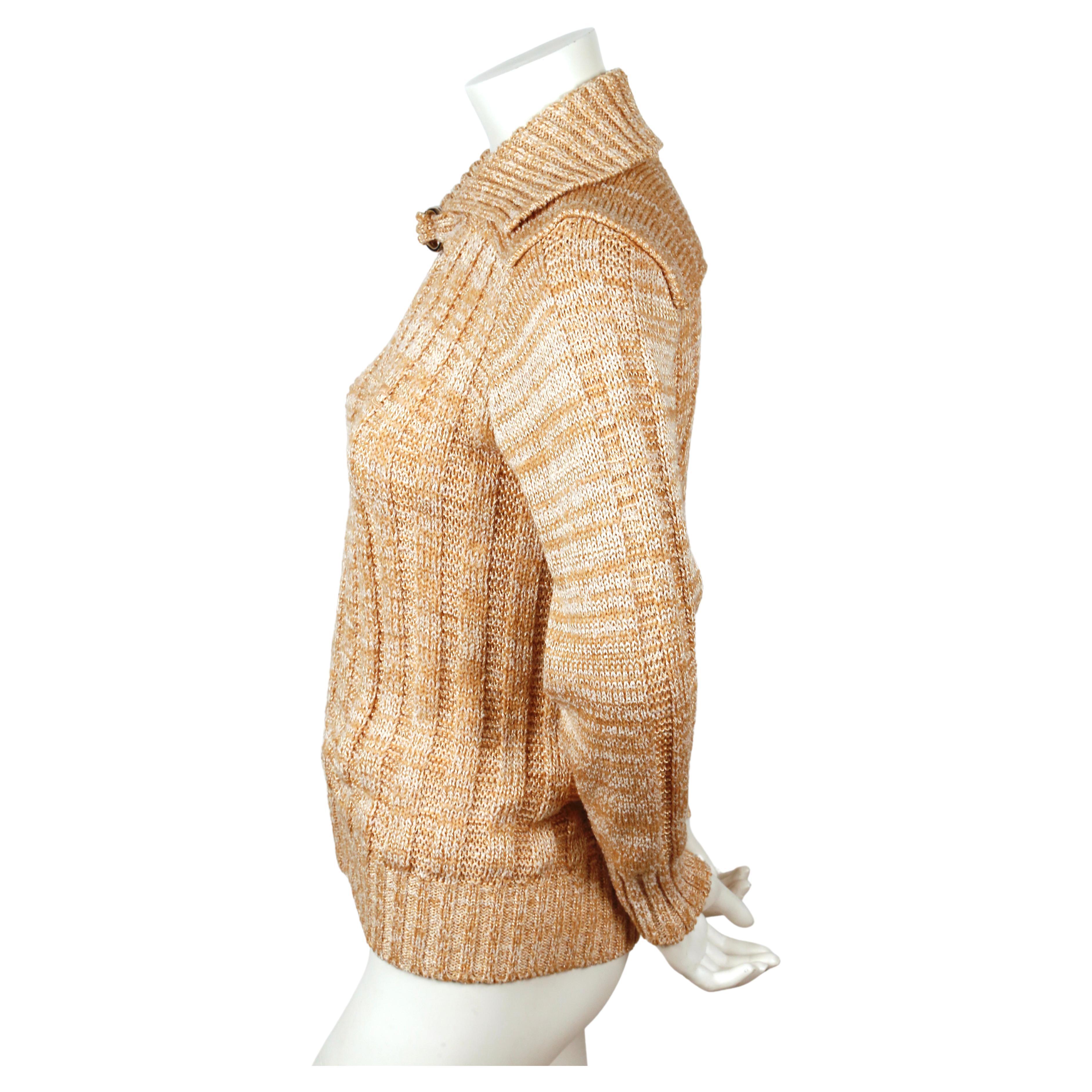 Marled peachy-tan and off-white cardigan sweater with exposed silver zipper, oversized collar with buckle and Courreges logo. Original hang tags are still attached! Labeled a size  0. Best fits a US 2-4. Approximate measurements (un-stretched):