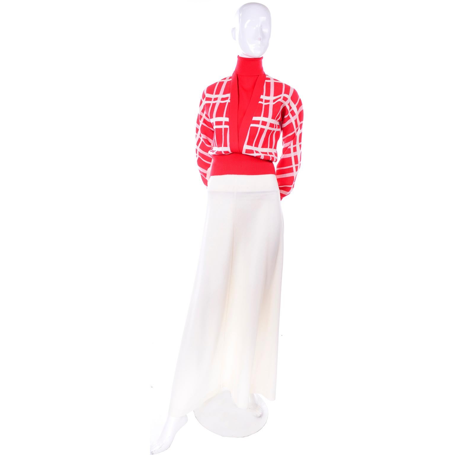 This is a wonderful, unworn, two piece knit outfit by Crissa Linea Italiana with the original tags. It has a turtleneck sweater top and maxi skirt. The top is red with white plaid stripes, and the long skirt is white. Made in Italy, Polyester