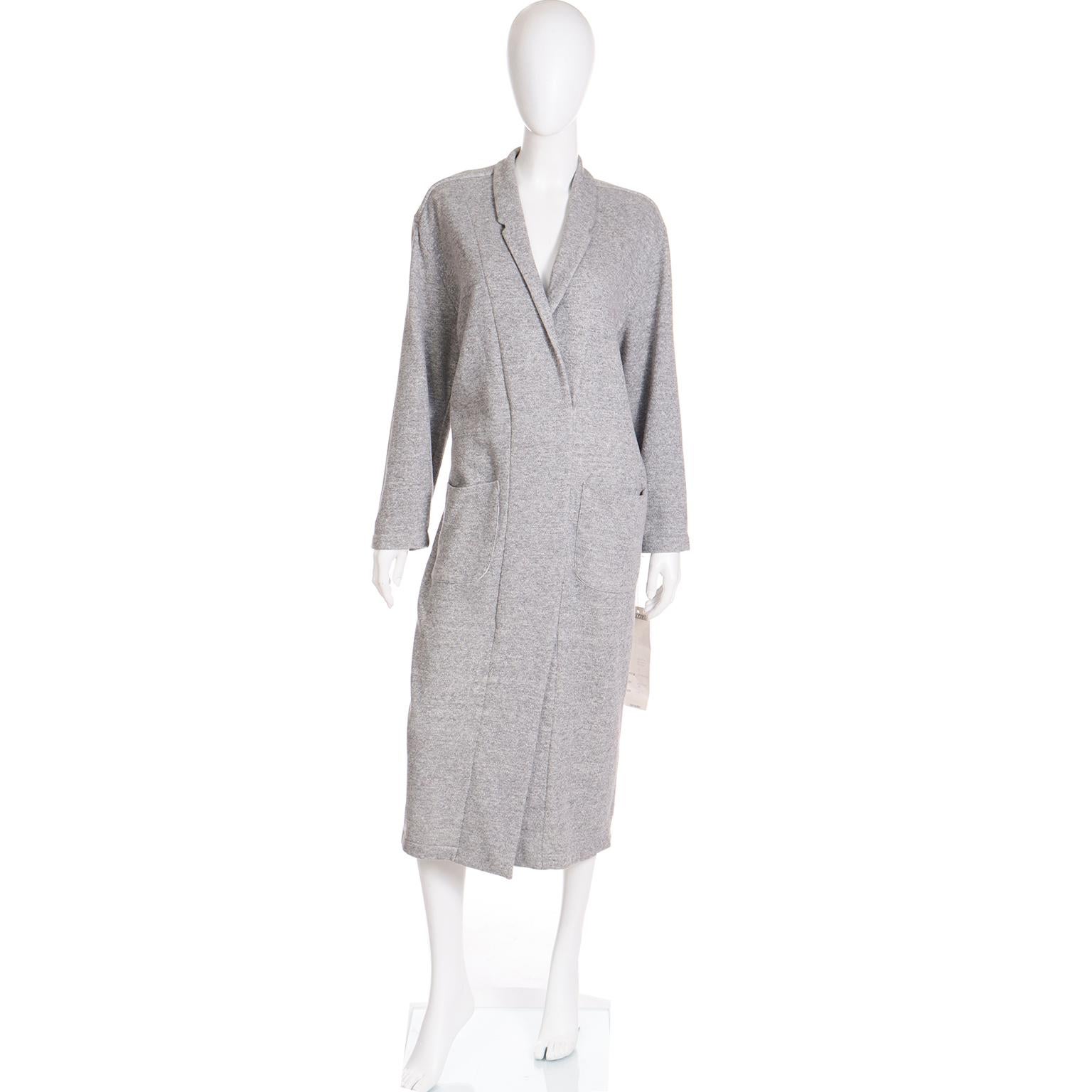 This cozy, fun vintage 1980's Norma Kamali dress is made from Kamali's signature grey sweatshirt fabric and it was never worn! This collectible dress slips overhead and has front patch pockets and a V front with no closures. You can wear it as shown