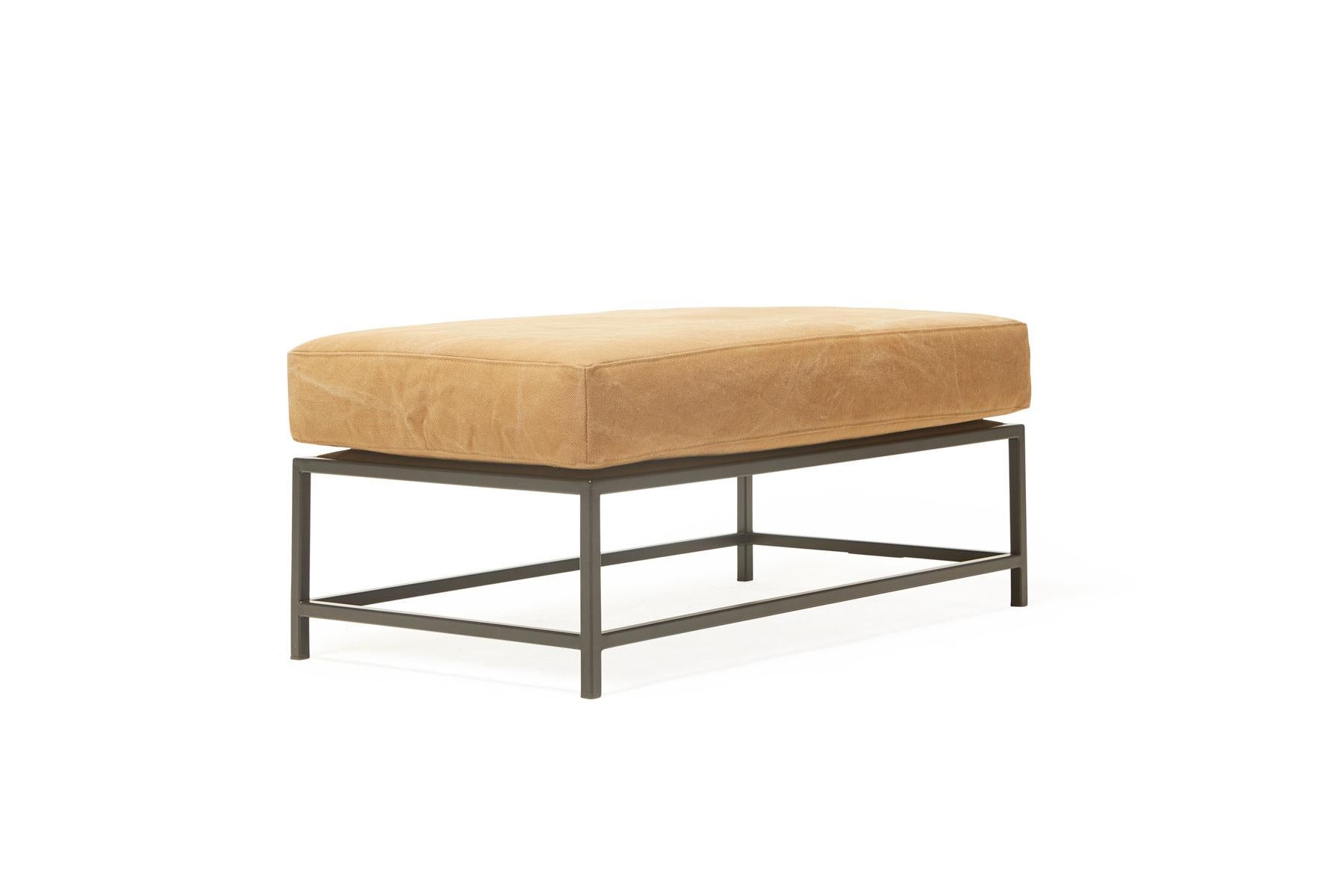 The inheritance bench is a versatile piece that can be used as a chaise extension on any sofa, as an independent seating option or as a large upholstered coffee table.

This variation is upholstered in a deadstock tan canvas. The foam seat