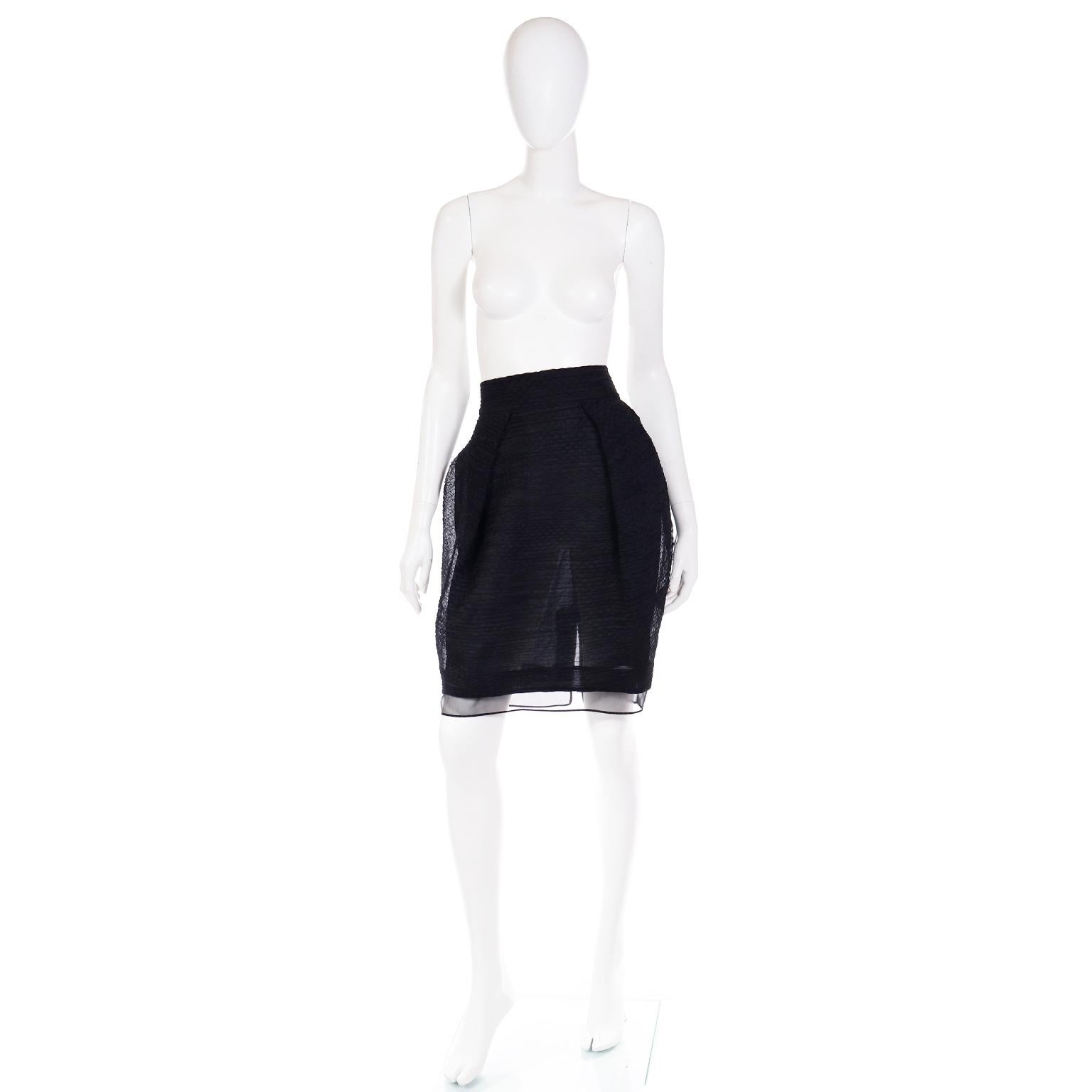This is an incredible vintage Gianfranco Ferre black evening skirt that was never worn and still has its original tags attached. This high waisted feather light skirt has a slight bubble silhouette and is made in a luxe silk crinkle fabric with a